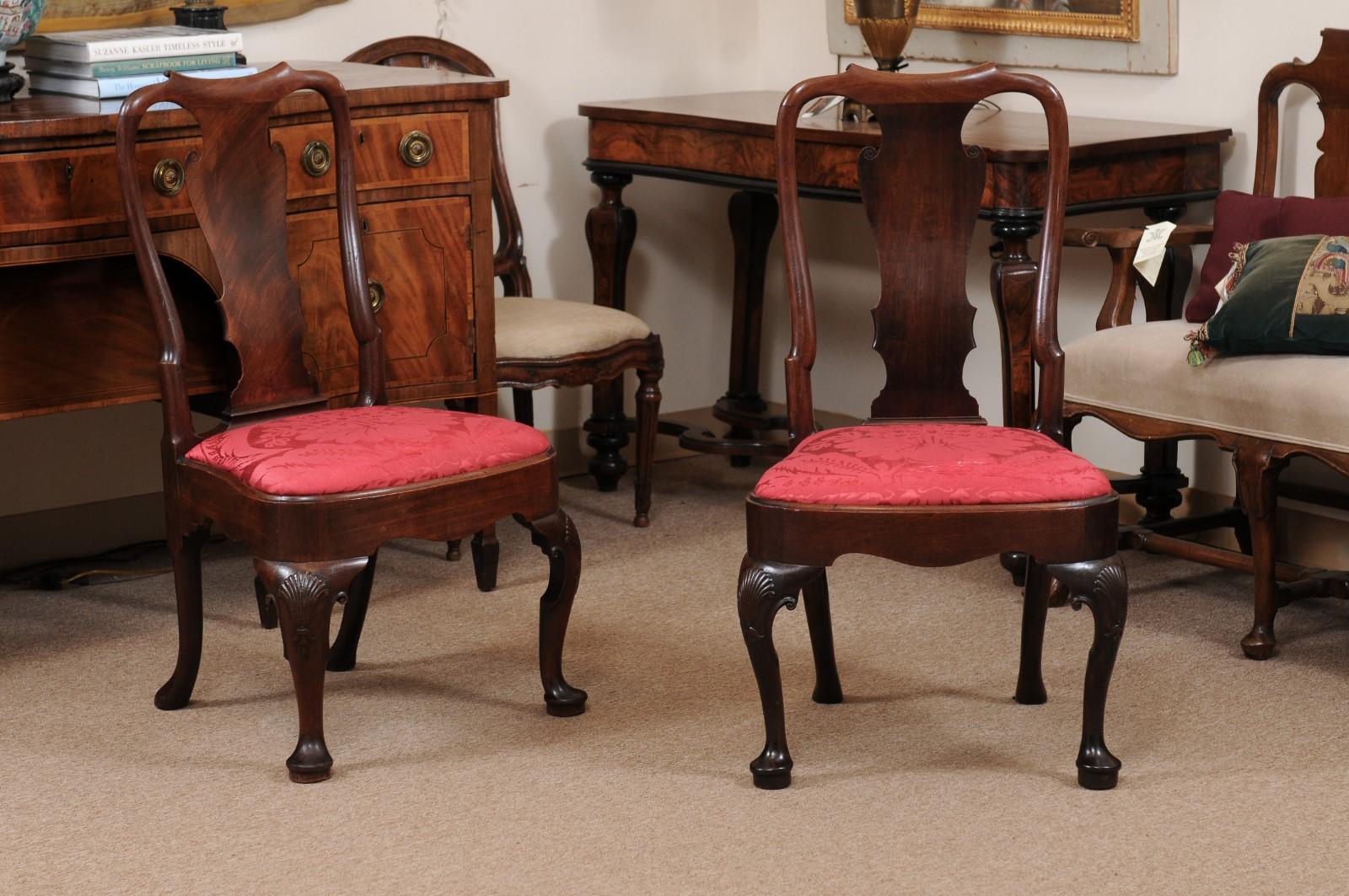 Pair of 18th Century English Queen Anne Period side chairs in walnut with cabriole leg, pad feet, and red Damask Upholstery.