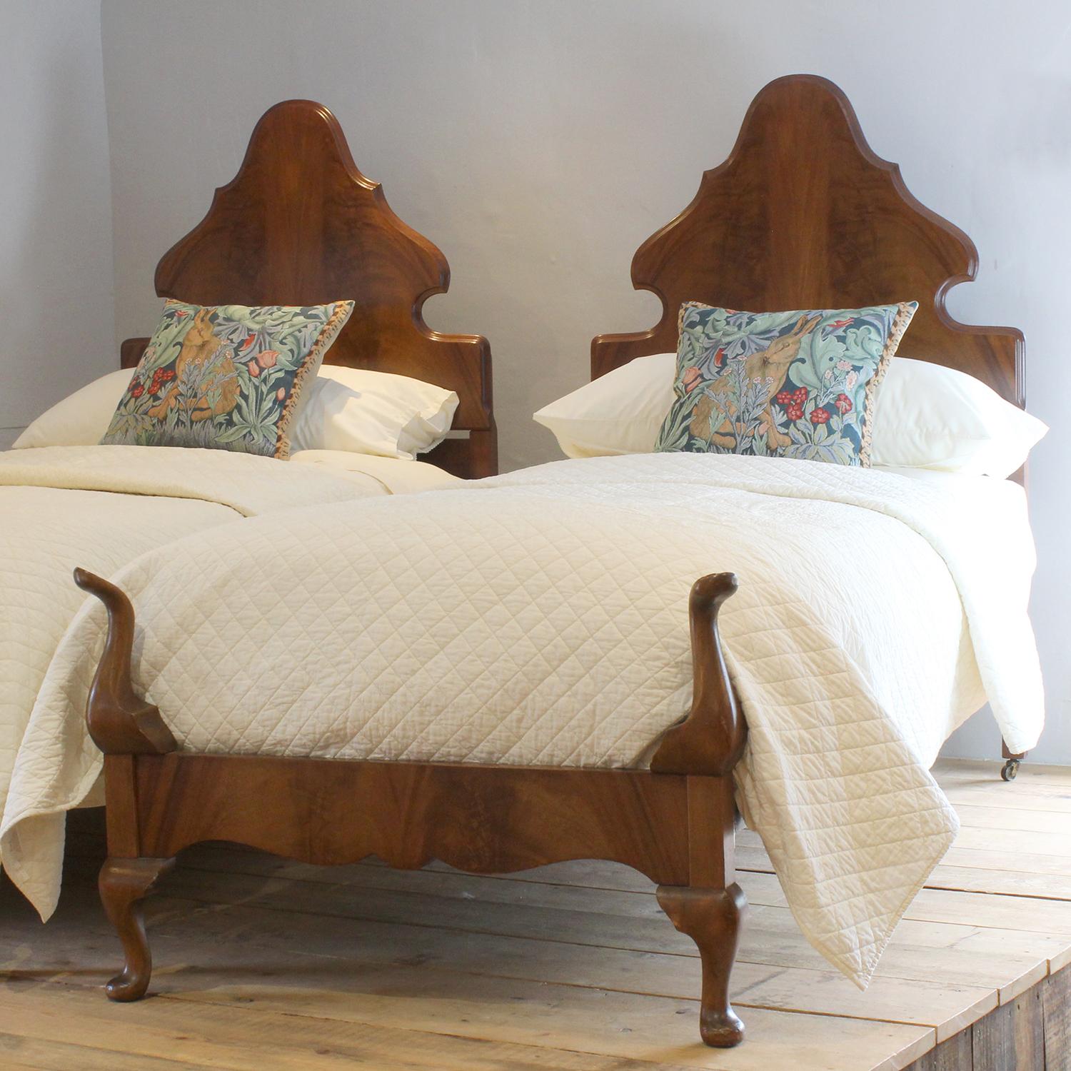 A fine matching pair of antique single beds in mahogany with flame mahogany veneer panels.
The beds accept wide single size bases and mattresses, 3ft wide (36 inches)
The price includes two standard firm bed bases to support the mattresses. 
The