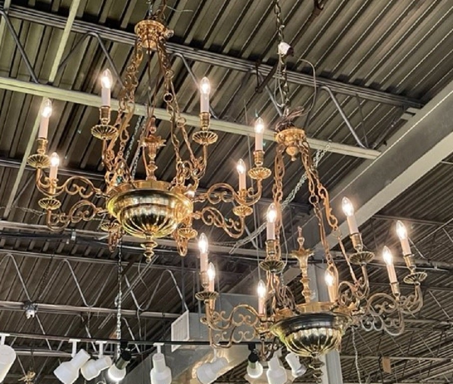Pair of Queen Anne style brass 8 light chandeliers with lobed bases.