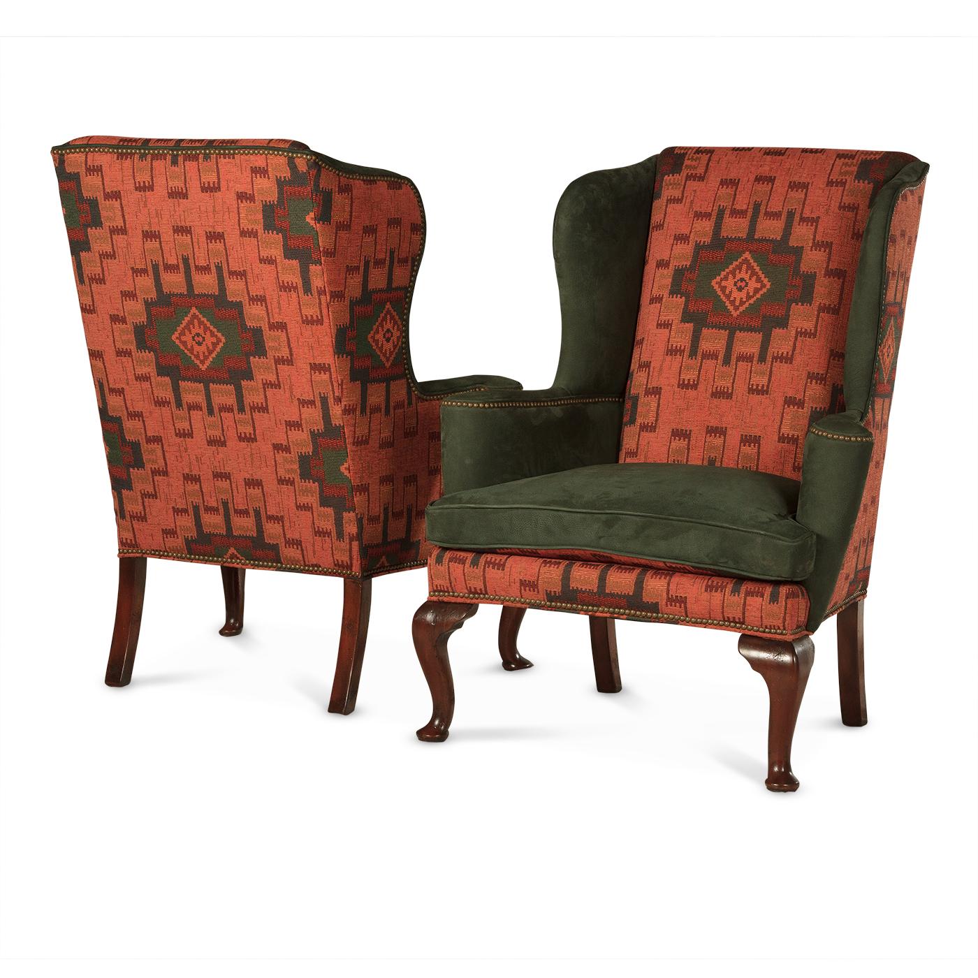 A pair of Queen Anne-style upholstered wingchairs. These classical designed Queen Anne wing chairs are custom upholstered with southwestern fabric and fine matching Nubuck leather, detailed with brass nailhead trim. Filled with comfortable down