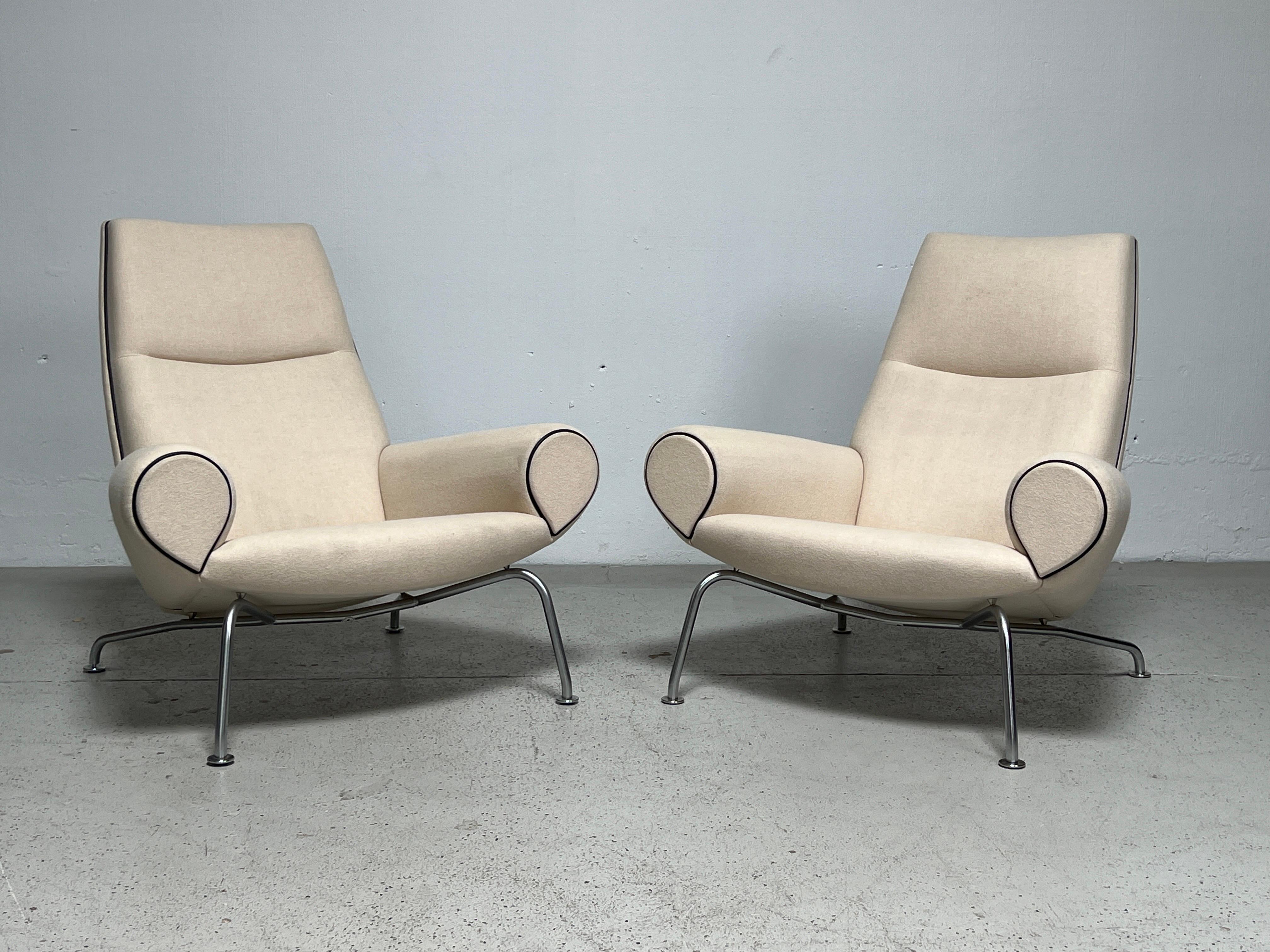 A pair of Hans Wegner Queen chairs by Erik Jørgensen. This pair made in the last 20 years with original wool upholstery with leather piping has been professionally cleaned and is in fine condition with minimal wear.