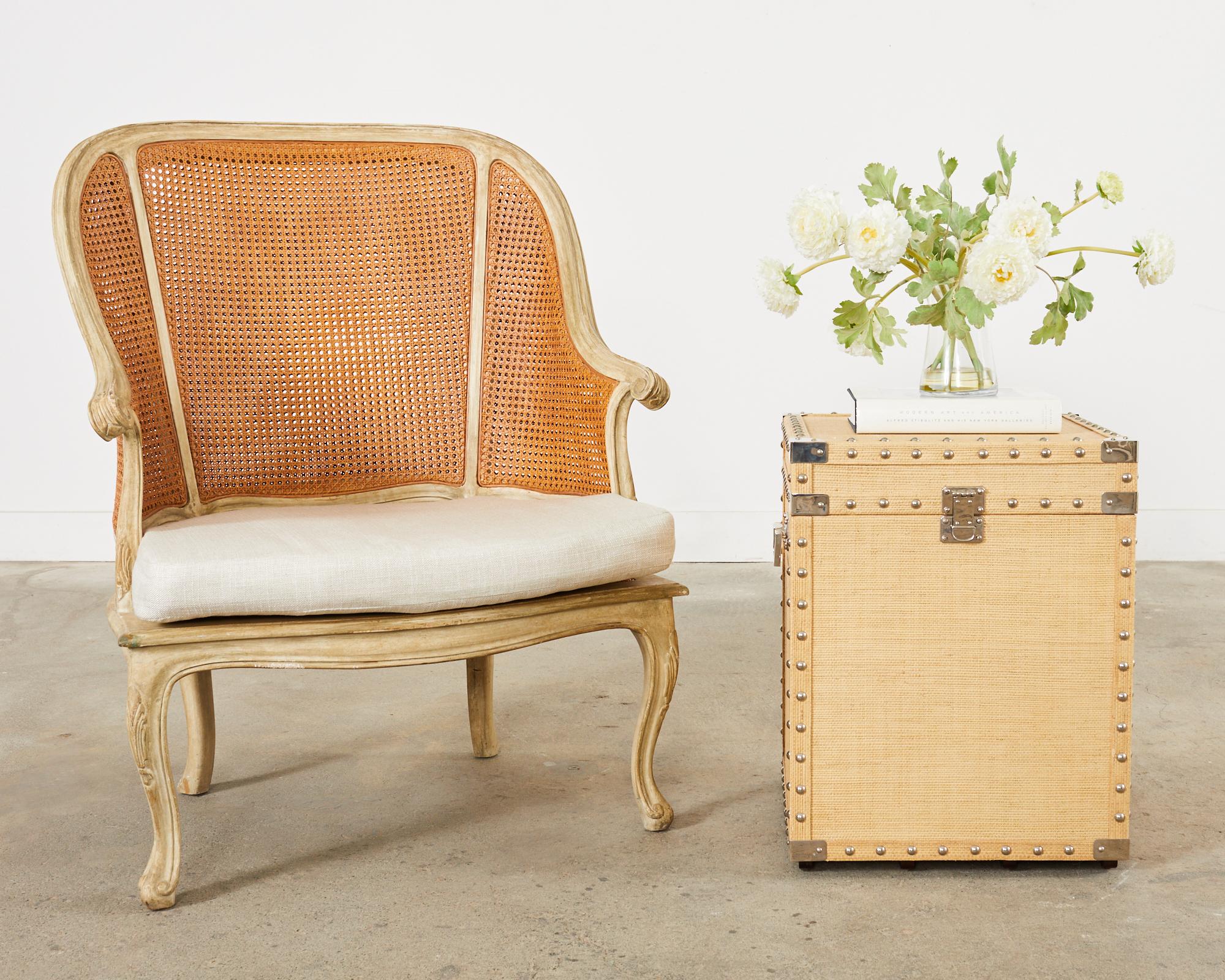 Gorgeous pair of mahogany hat trunk cube shaped storage boxes or side tables featuring a raffia grasscloth clad exterior. The lidded trunks have decorative metal studded borders and brass nickel finished corners, handles, and faux lock plates. The