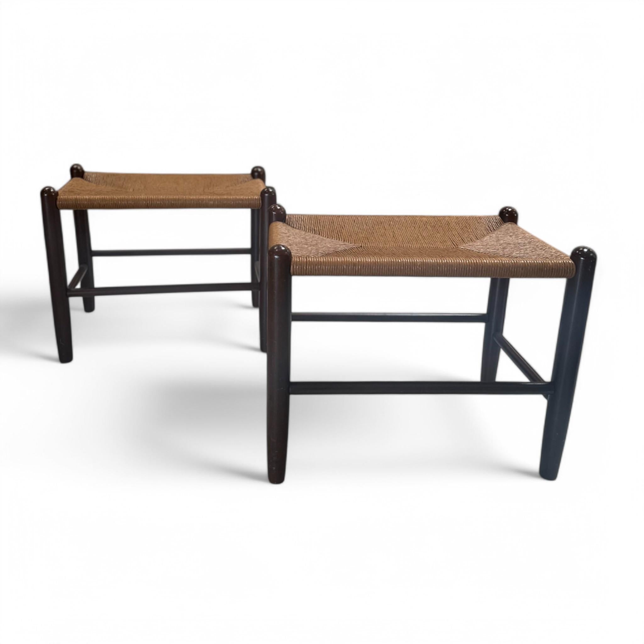 This pair of mid-century inspired raffia stools blends natural texture with sleek wooden frames for a timeless, versatile look. Perfect as extra seating, footrests, or side tables, their clean lines and woven seats add warmth and character to any