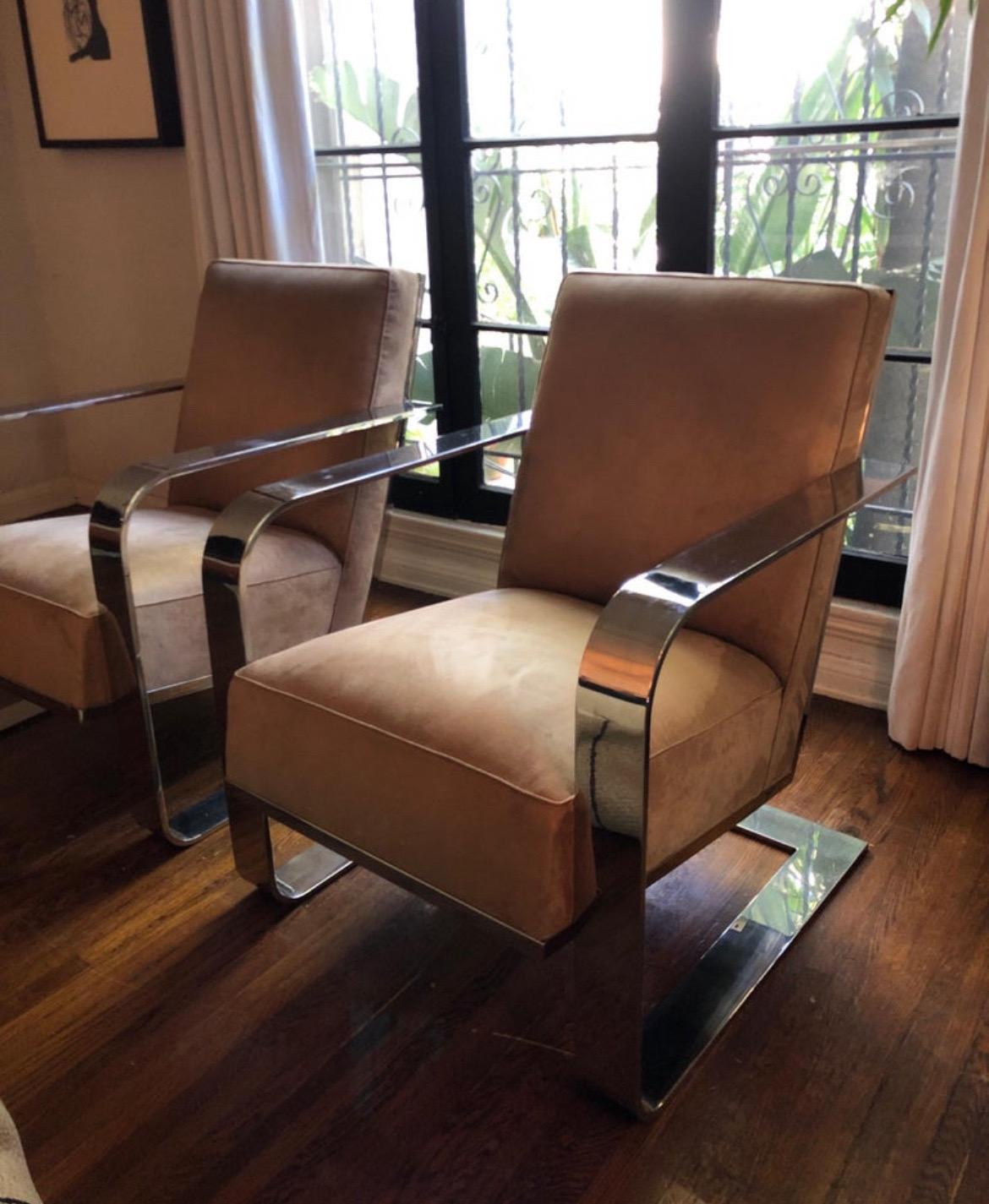 Sleek and sexy Ralph Lauren chrome lounge chair upholstered in a luxurious tan sued fabric. Impressive large presence balanced with reflective attributes and the aforementioned neutral color. The coveted chrome flat bar frame features oversized arm