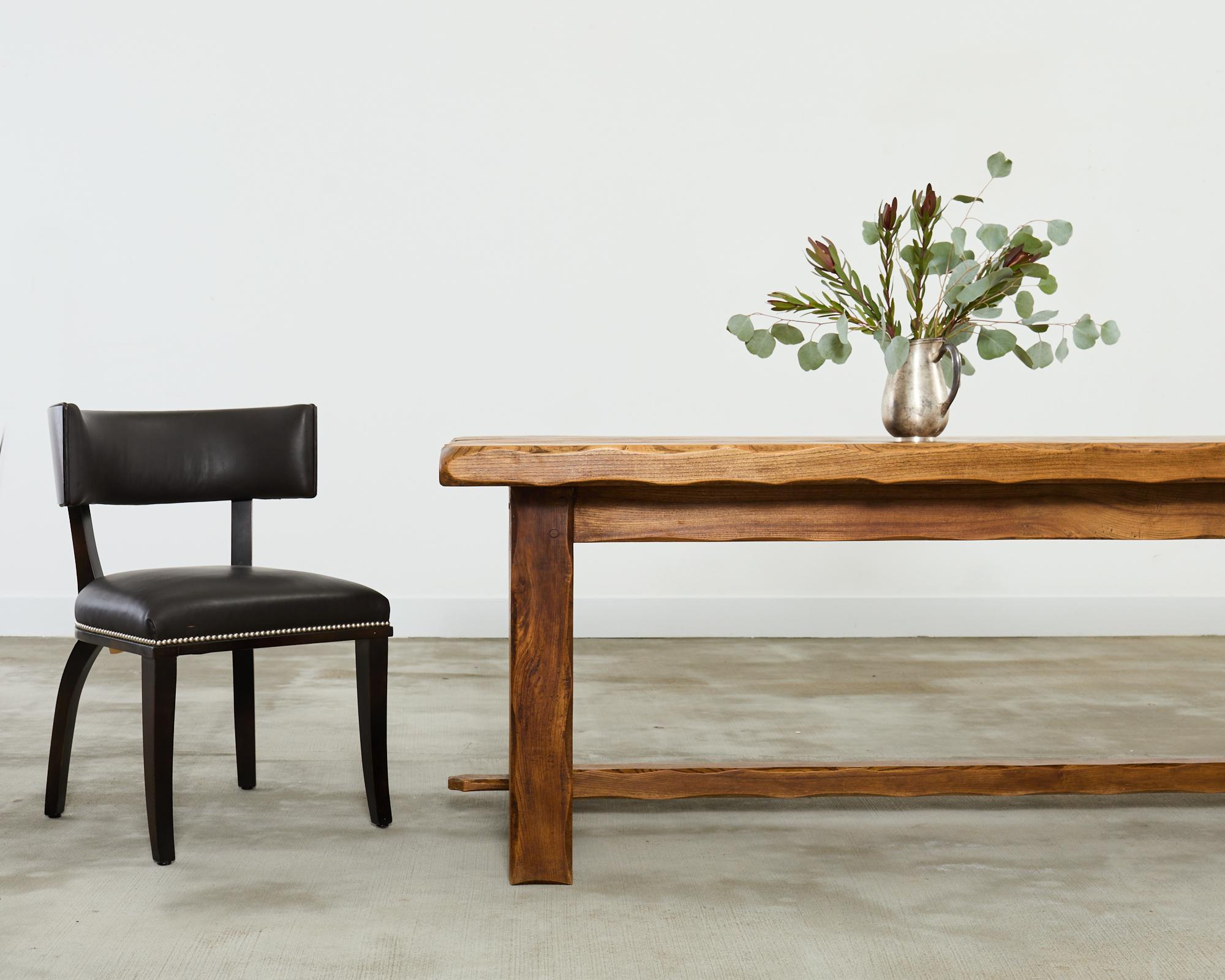 Dramatic pair of neoclassical style Clivedon dining chairs designed by Ralph Lauren. The Italian bench made bespoke chairs feature a klismos style beech frame with a rich faux Macassar ebony veneered tablet backrest. The frames are upholstered with