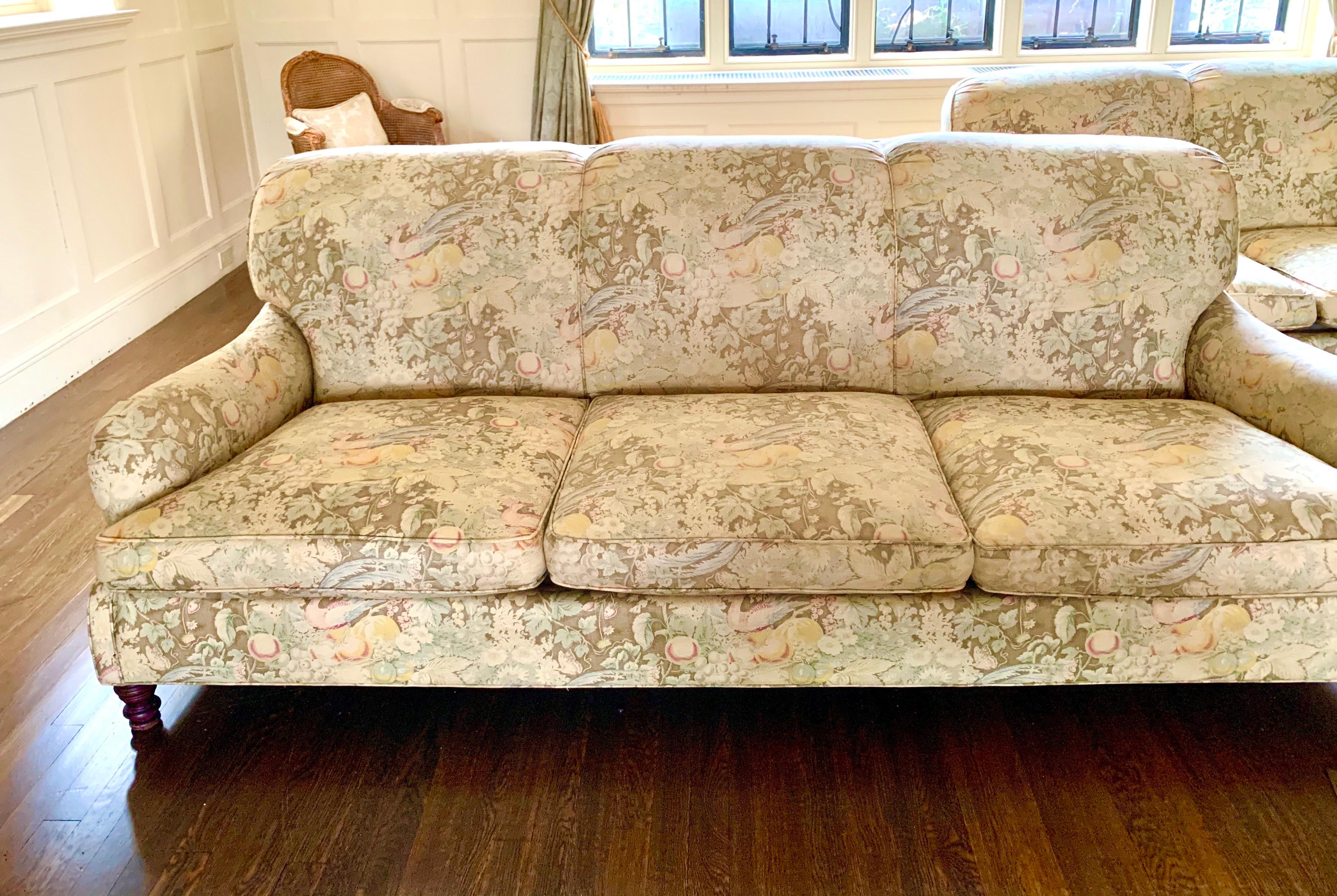 Elegant pair of matching vintage signed Ralph Lauren three-seat sofas.
These vintage sofas, circa late 1970s, are all original and have down cushions. The fabric, also original, features a park like setting with birds, fruit and vegetation.