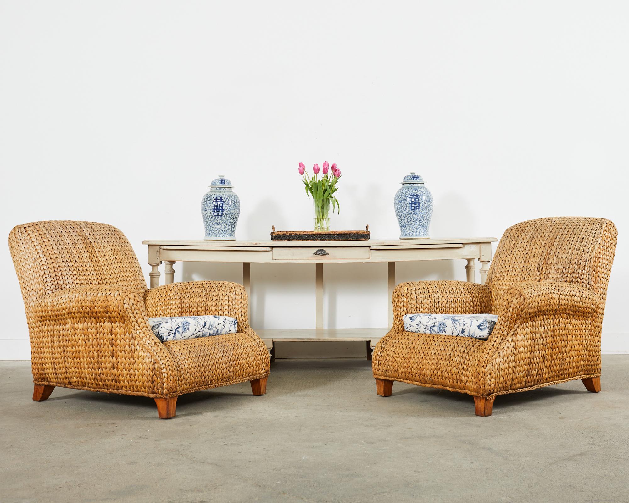 Rare pair of large woven seagrass and rattan lounge chairs or armchairs designed by Ralph Lauren. The chairs feature oversized rattan frames embellished with natural woven seagrass in the coastal organic modern style. The chairs are very sturdy and