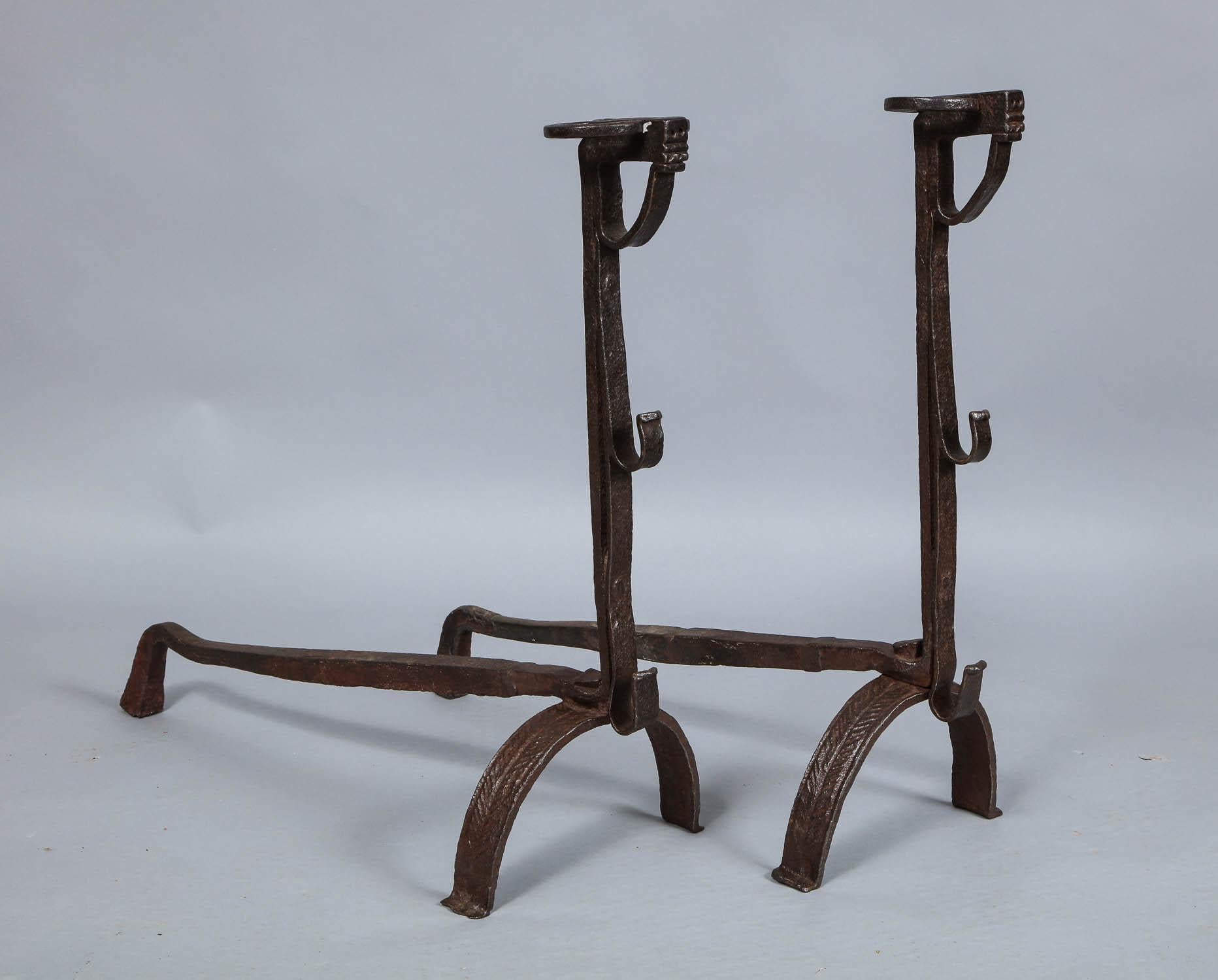 A fine pair of large English 18th century blacksmith-made wrought iron andirons with distinctive 