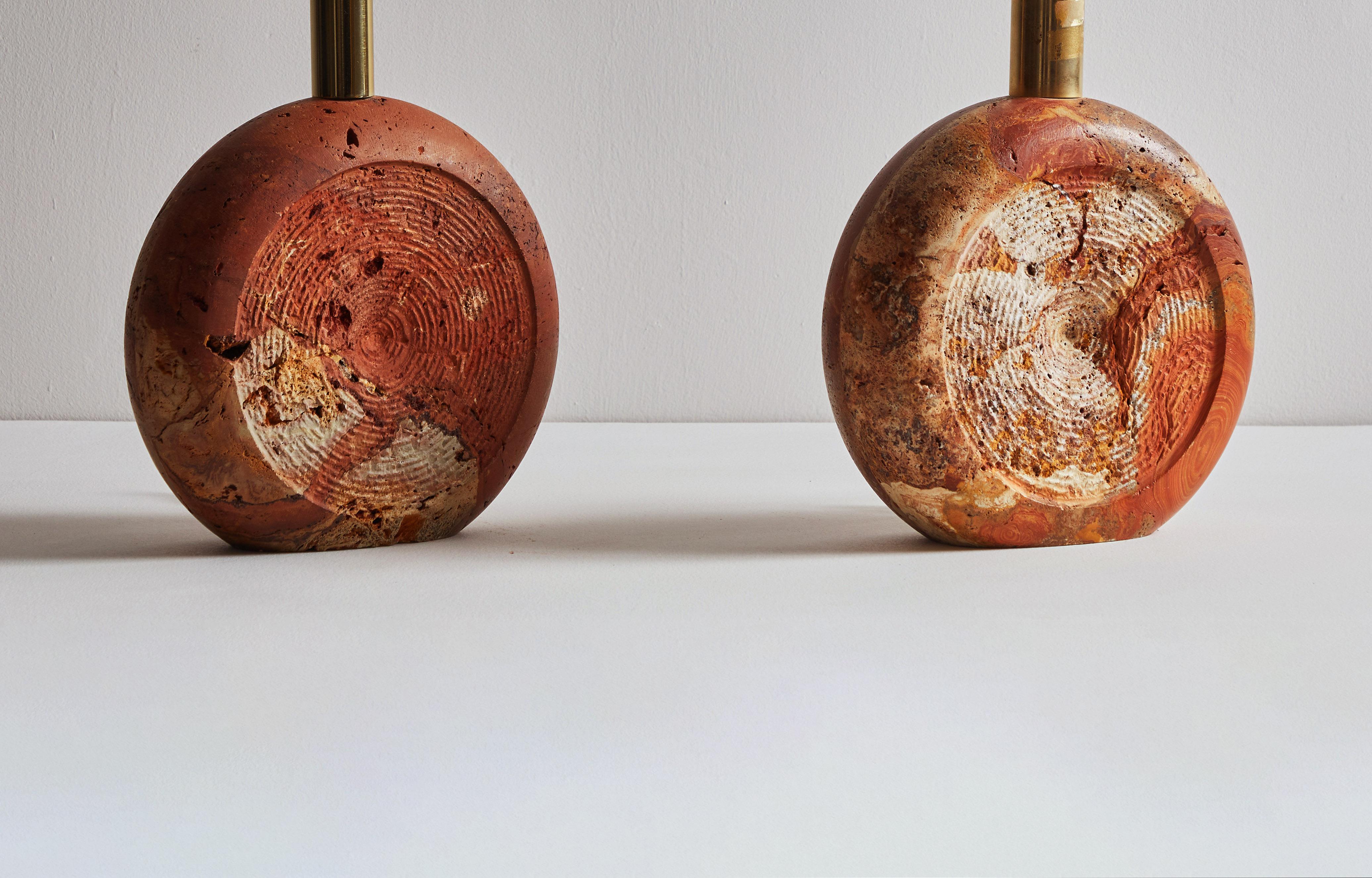 Pair of Travertine table lamps by Fratelli Manelli. Designed and manufactured in Italy, circa 1960s. Rapolano red travertine, brass. Original cord, wired for U.S. sockets. Custom shades available upon request for an additional fee. Retains original