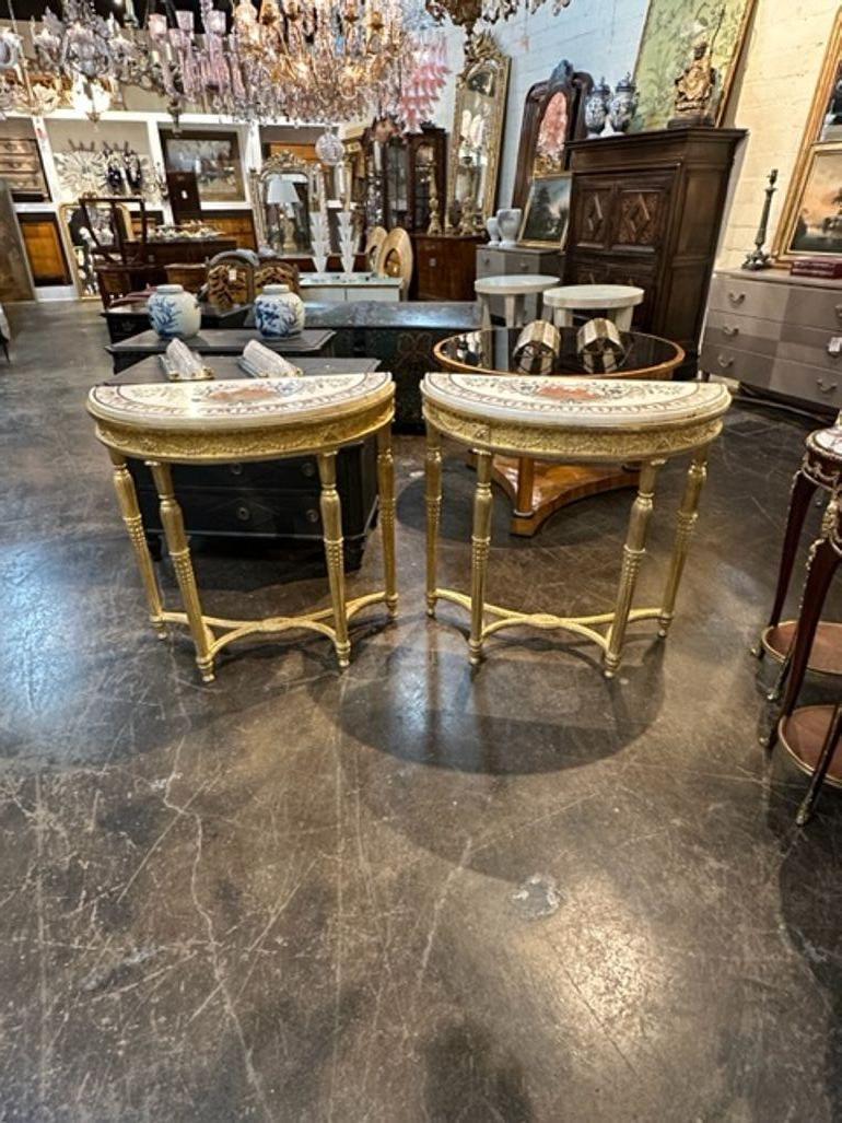 Exceptional pair of 18th century rare English George III giltwood consoles with inlaid marble tops. Featuring beautifully carved giltwood and multi-colored inlay on the marble tops with a Neo-Classical scene. These are true works of art! Stunning!!