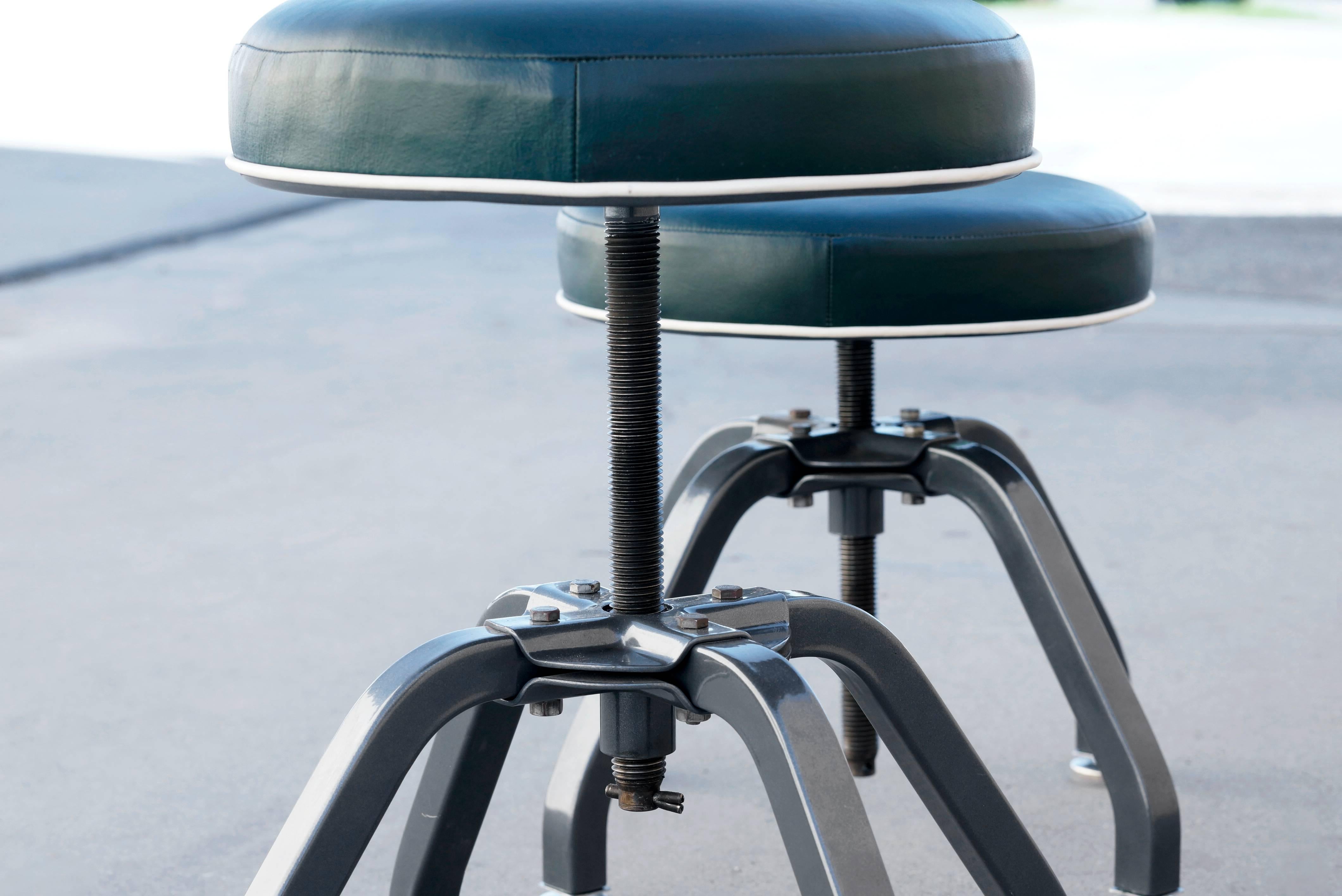 Very rare pair of vintage chrome salon stools from Buty-Crafters. These were rescued from a 70 year old beauty supply manufacturing facility in Los Angeles. Freshly powder coated bases in dark metallic grey. Reupholstered in recycled dark green