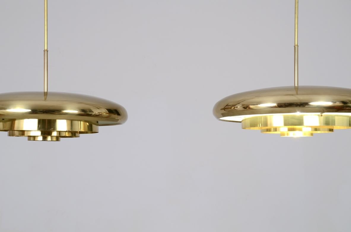 COD-1977-1978
Pair of rare 1960's ceiling lamps with a large nice shaped brass shade.

Prod. Bergboms, Sweden.

50 diam