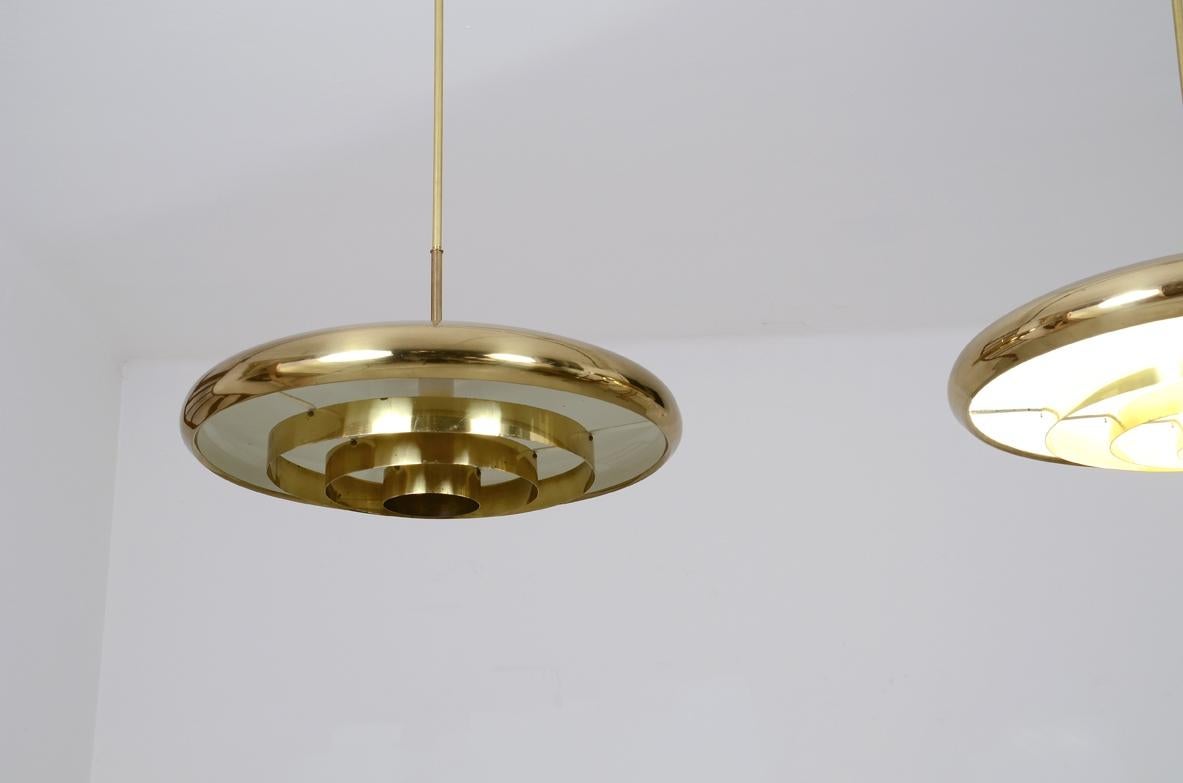 Swedish Pair of rare 1960's ceiling lamps with a large shaped brass shade