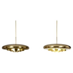 Pair of rare 1960's ceiling lamps with a large shaped brass shade