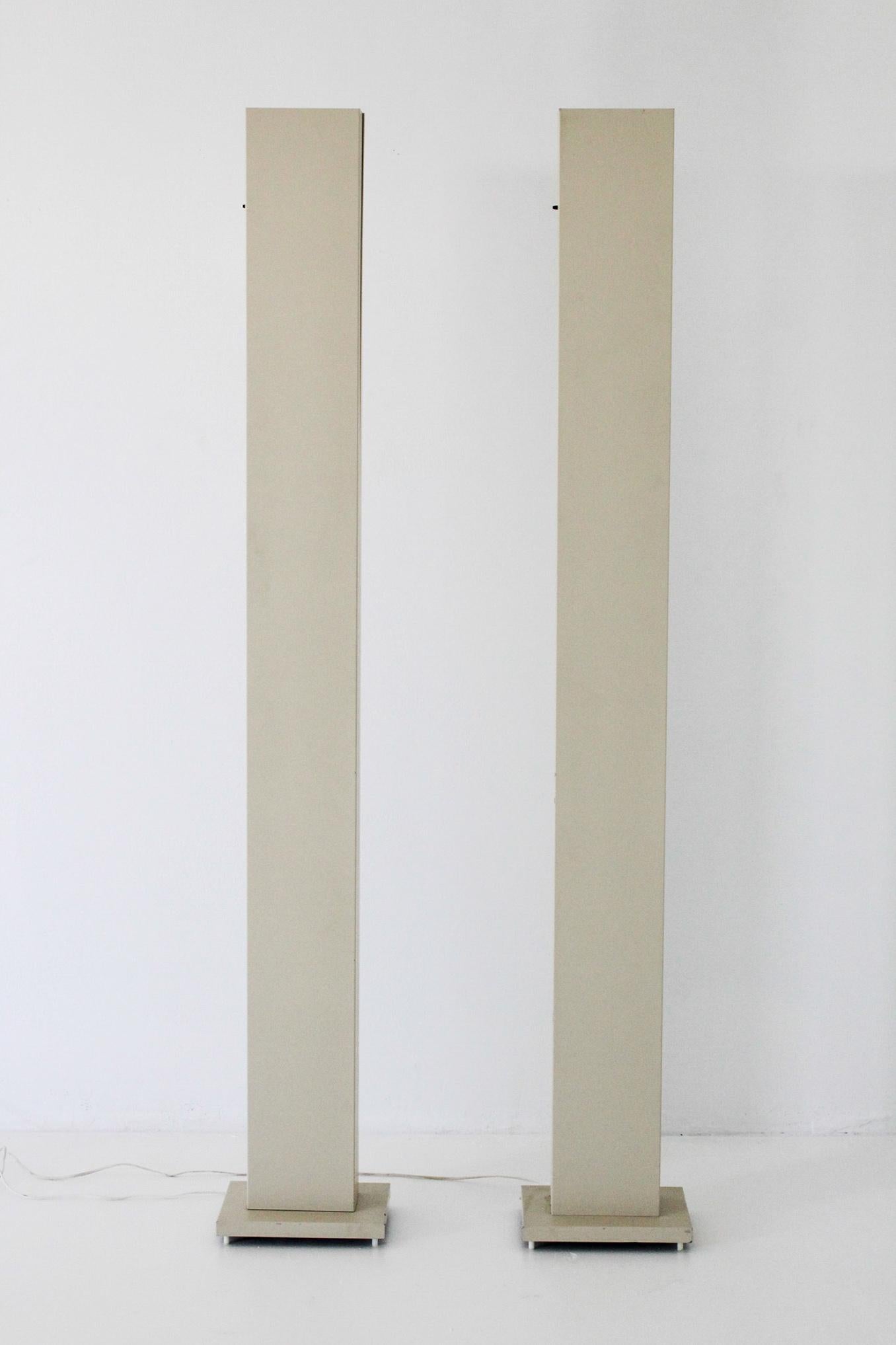 A Rare Pair of architectural form enamel monolith skyscraper halogen torchiere floor lamps by Casella Lighting San Francisco. Lamps are a rare finish as they are commonly brass or chrome finish. Lamps are in nice vintage condition with a few small