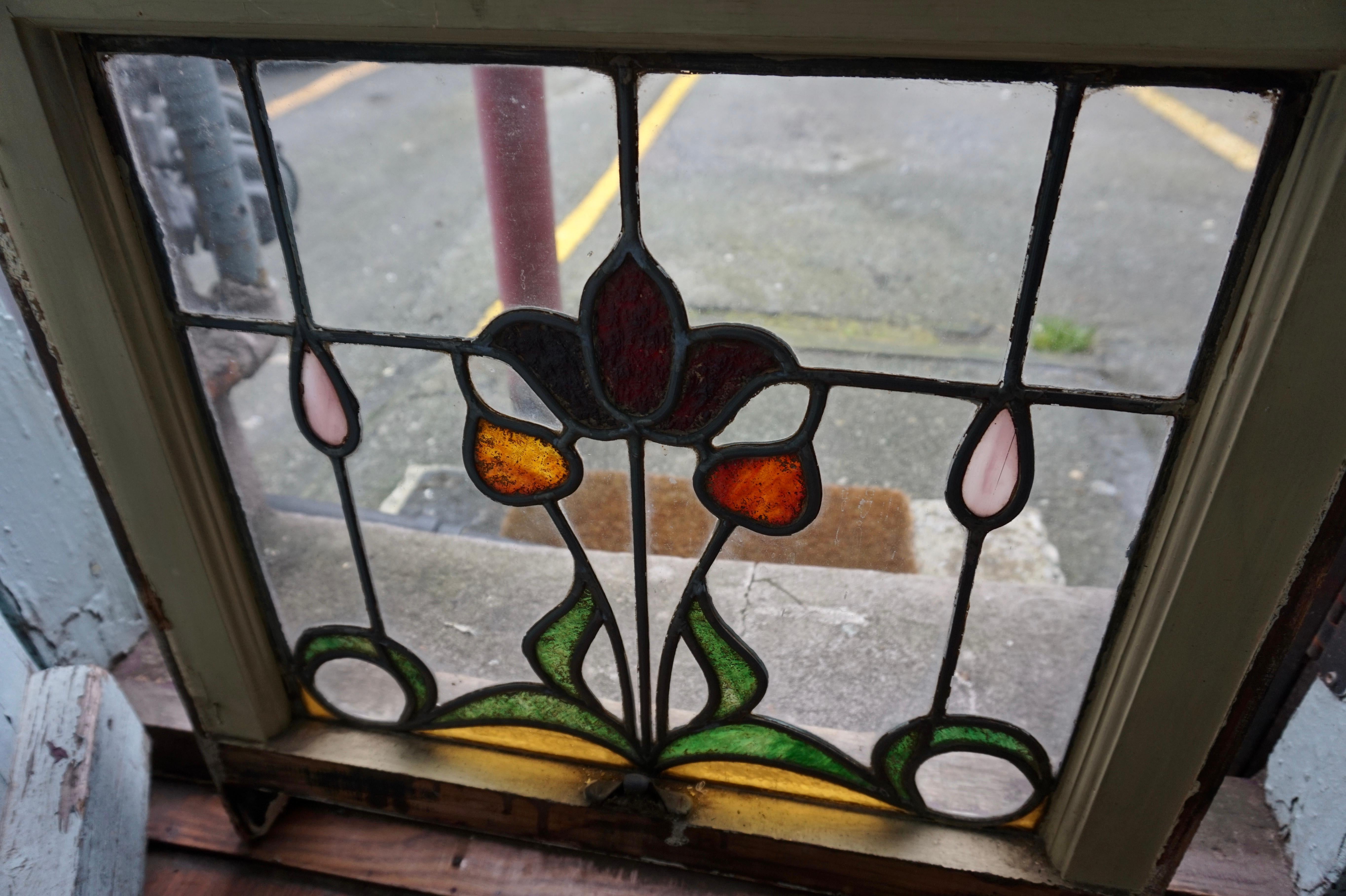 Hard to capture the beauty of these rare stained glass Art Nouveau windows. They come alive when let by natural sunlight to display dazzling warm hues. In good overall condition with some age showing on the frame edges but overall sturdy. The