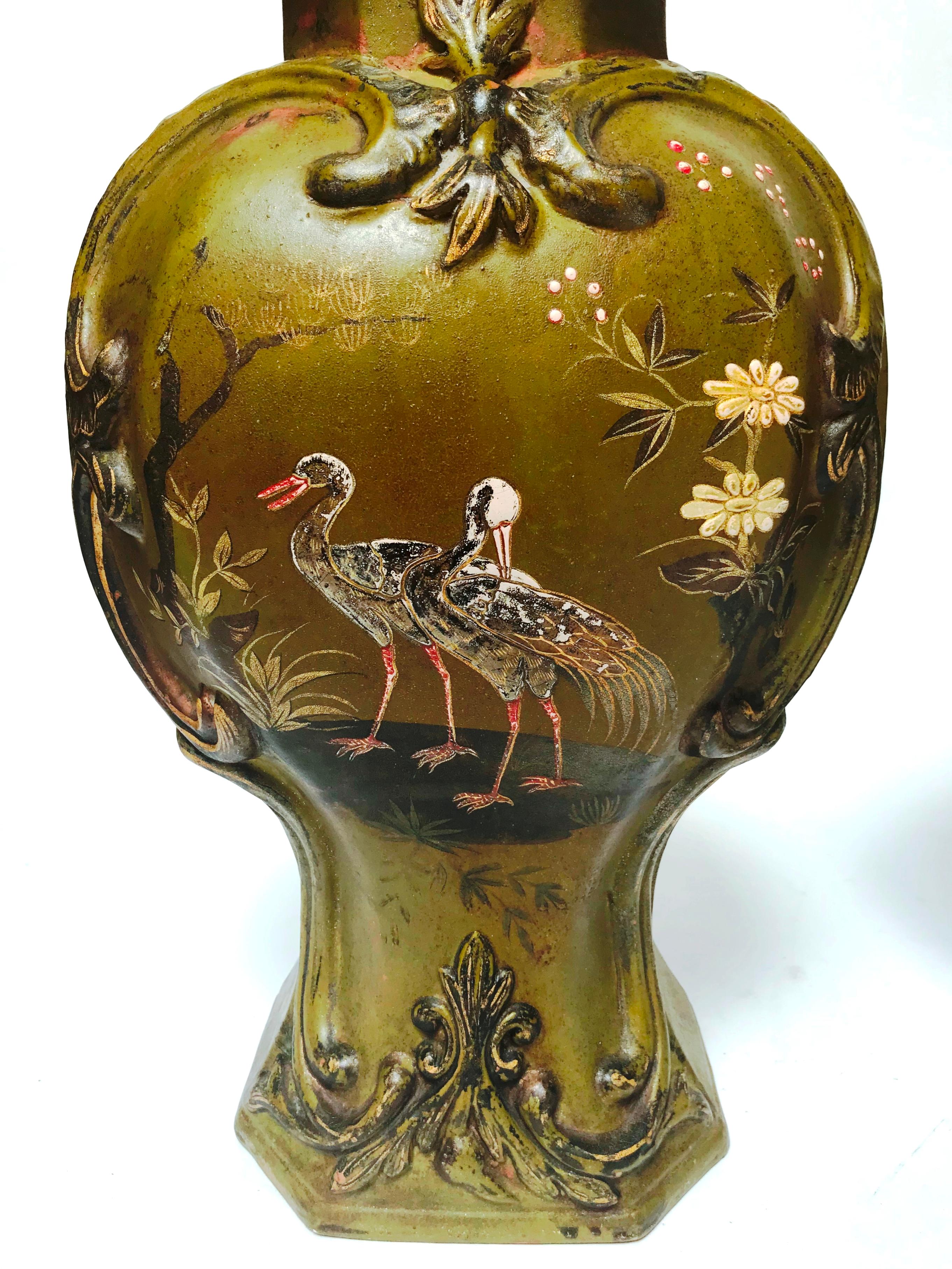 Each of baluster form, with a domed cover and
lion knop, designed in a deliberate blend of
chinoiserie: flowers and cranes and an oriental
form, and Rococo motifs: scrolled foliate forms
in raised relief, the decoration hand painted in
colored