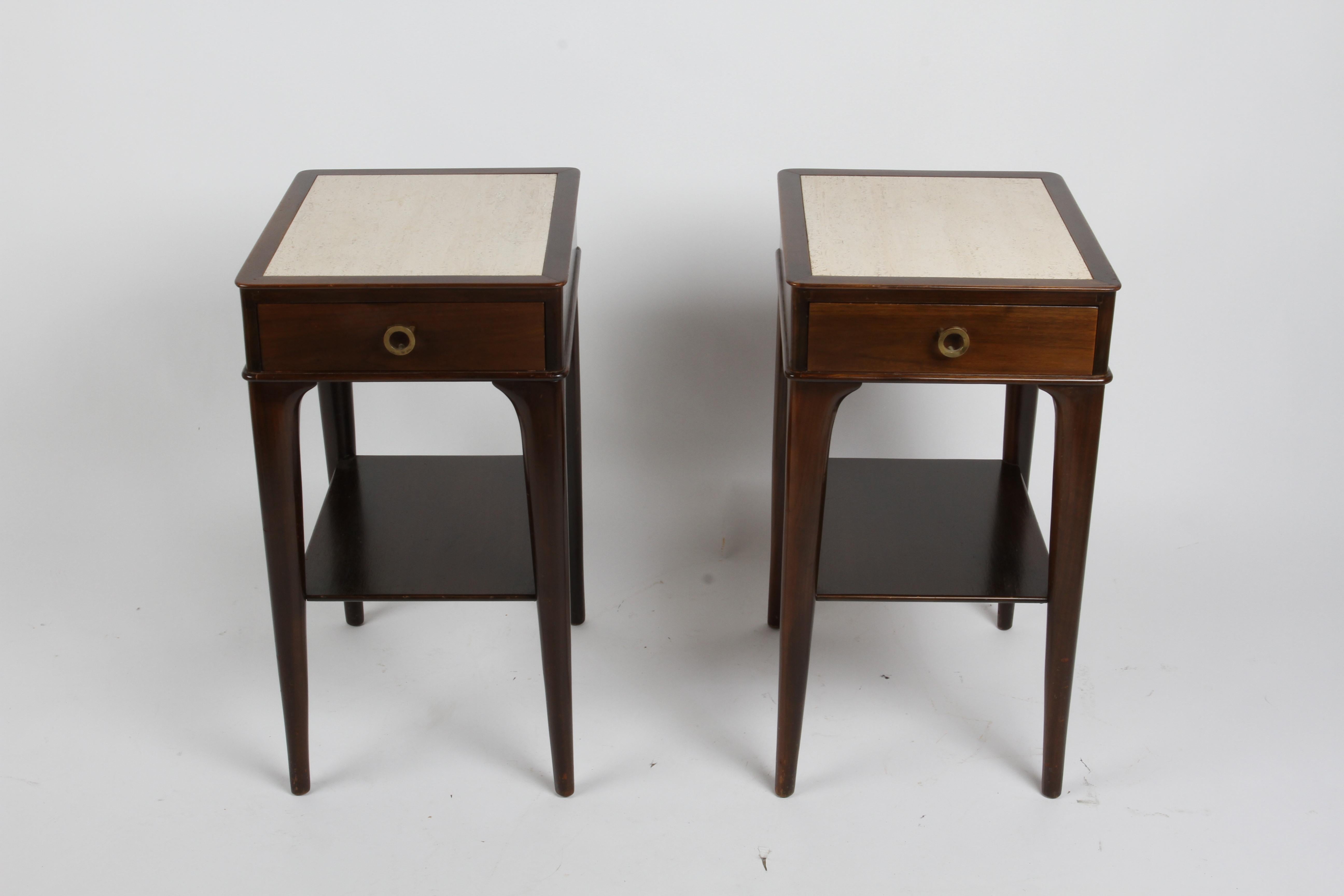 Rare and very elegant pair of nightstands or end tables designed by Edward Wormley in dark stained mahogany with travertine tops, single drawer has open circular brass pull, from his Dunbar for Modern collection. 
No labels but shown in my Dunbar