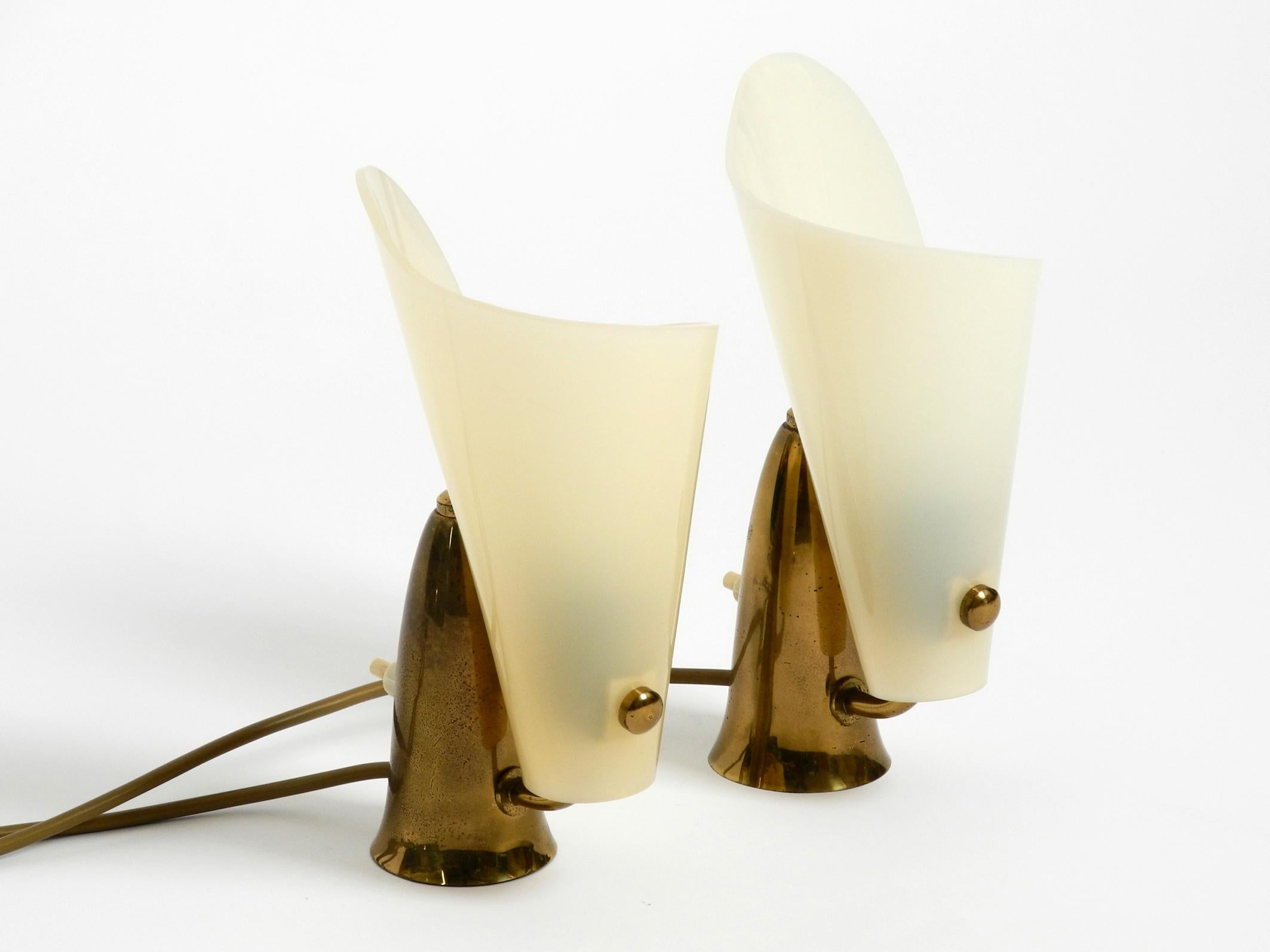 Pair of very rare and beautiful fancy Italian midcentury brass table night lamps
with plexiglass shades.
Fantastically beautiful Italian design with the brass bases and the rolled shades
made of plexiglass.
Typical design from that time, in a