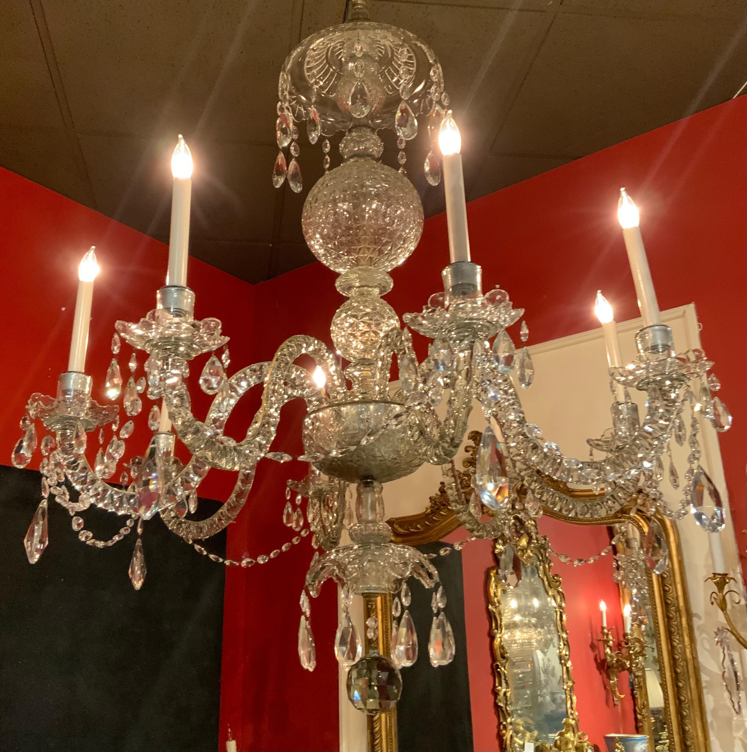 The exceptional quality of Waterford crystal is apparent in the
Quality of these chandeliers. They are large, each having eight 
Scrolling arms with cut crystal bobeches and each ending
in crystal pendants. The central post is made of the