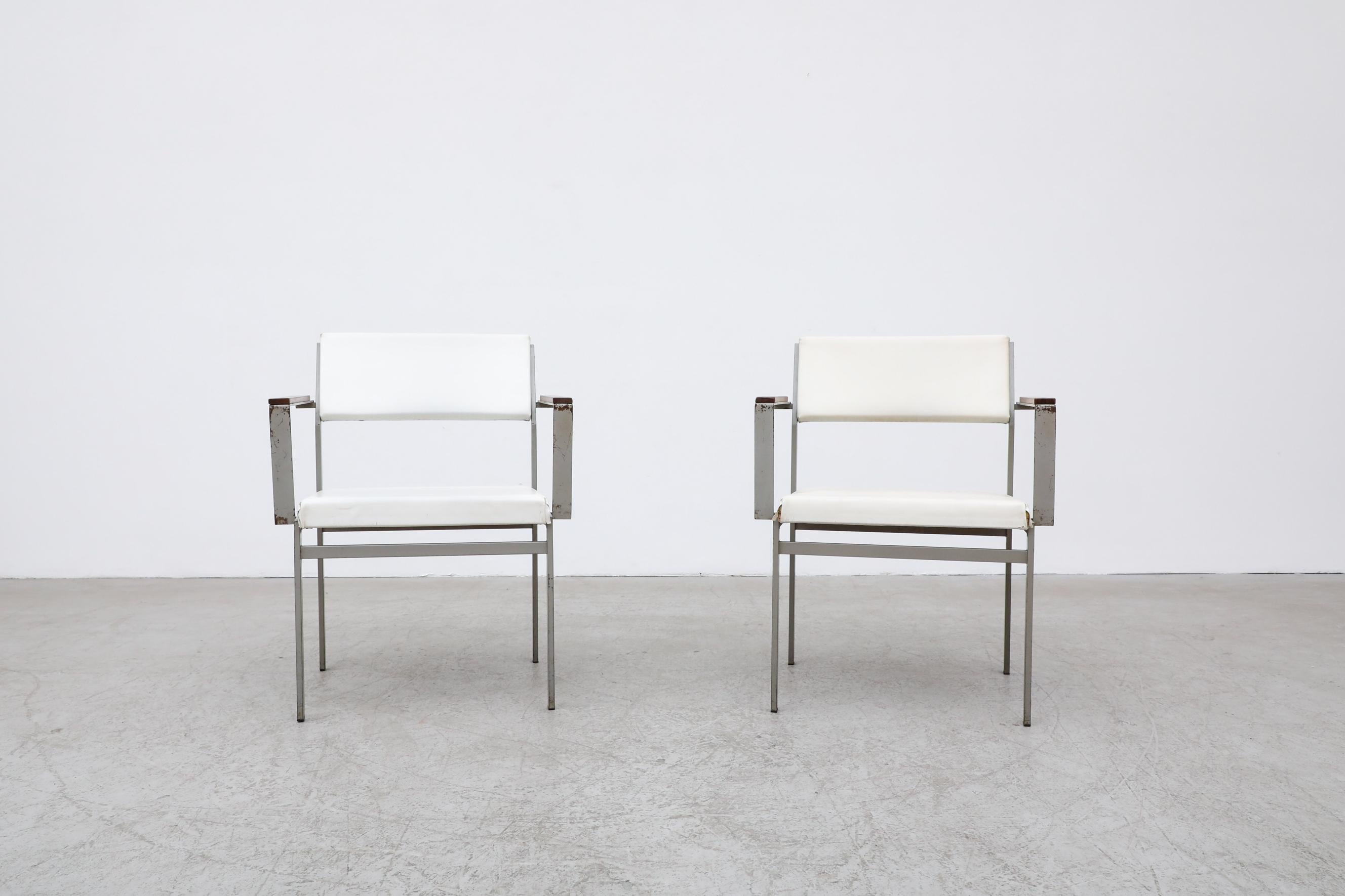 Designed by Cees Braakman for Pastoe, this rare set of chairs dates back to the 1950s. It features a sturdy metal light grey frame with thin teak armrests and faux leather white seating. These chairs are in original condition and have visible enamel