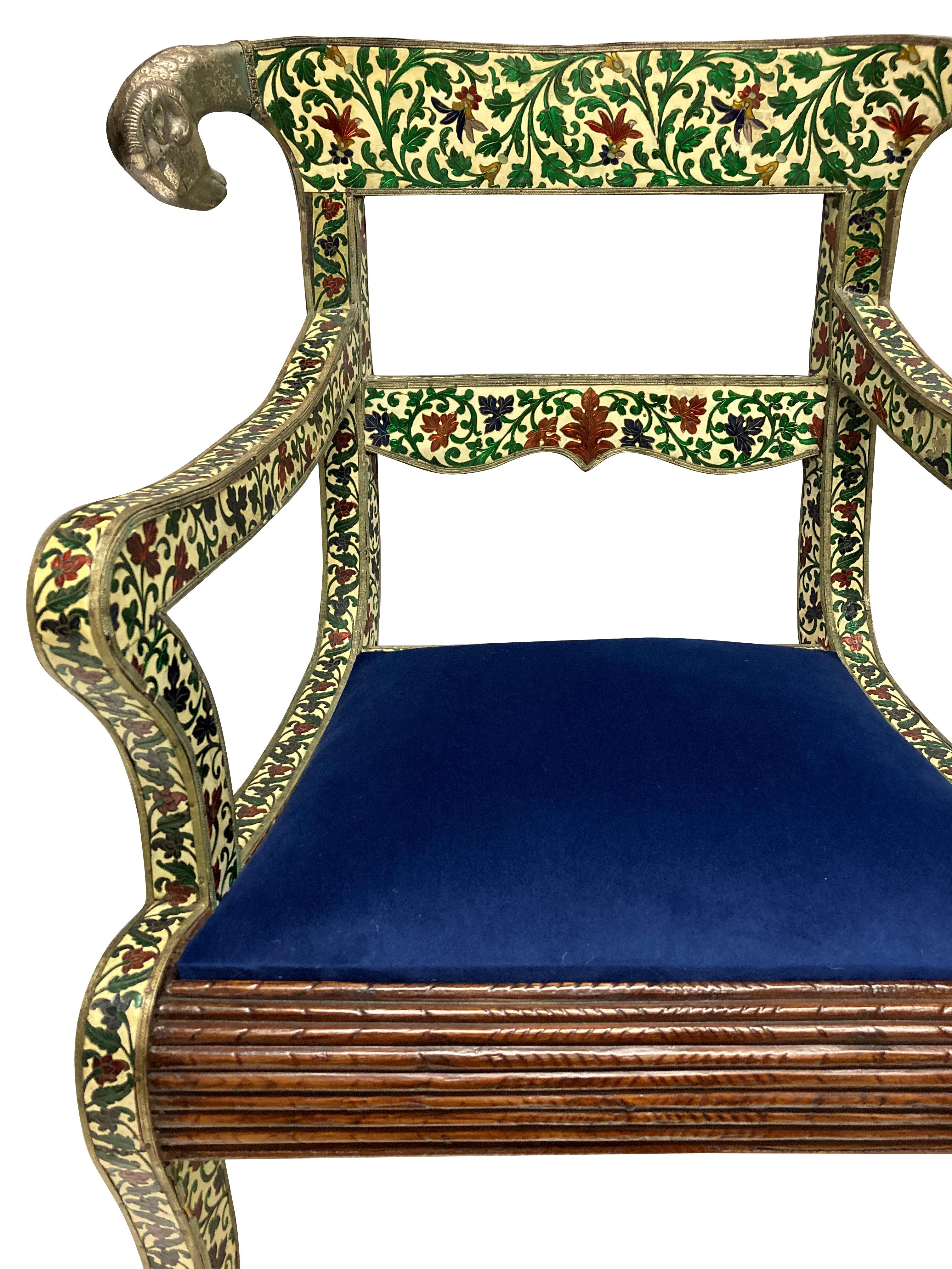 A rare pair of Indian cloisonne and silver armchairs in the Regency manner. In hardwood and covered in beautifully decorated enamel depicting flowers and foliage, with repousse silver decoration. The original drop in seats were in Imperial purple