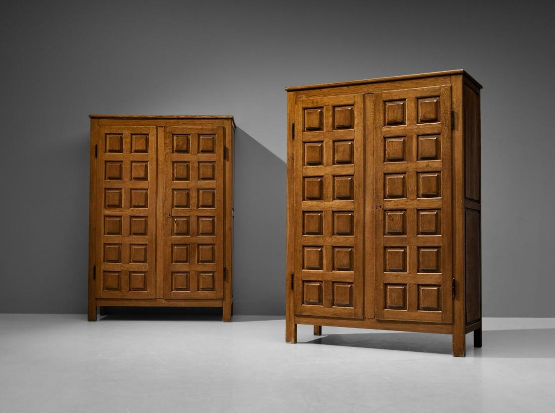 Pair of rare Italian 1960s Brutalist carved oak wardrobes. The front doors feature a rhythmic pattern of precisely carved squares, highlighting the architectural aspects of structures in wood. Functionality comes into play through the availability