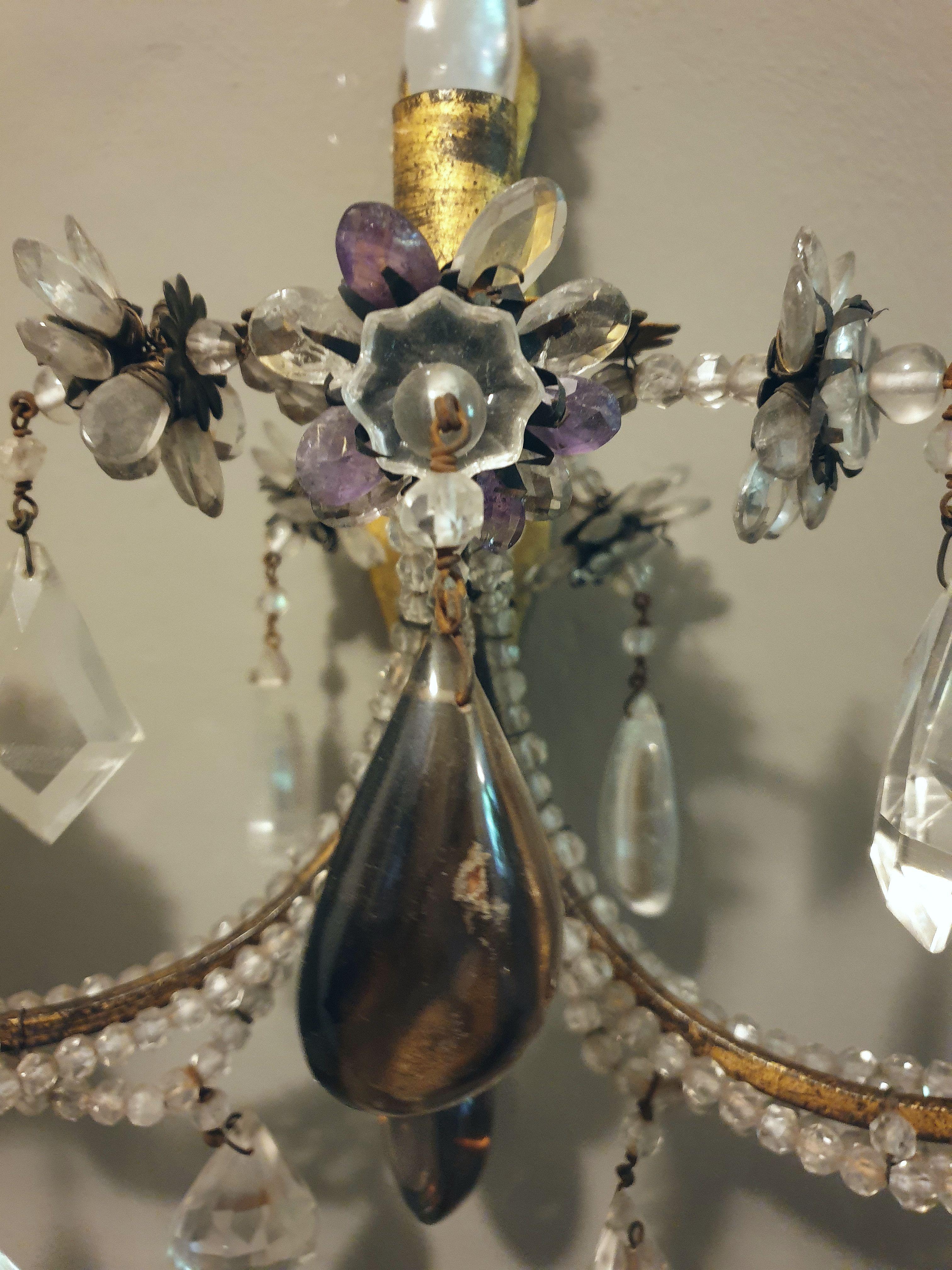 This pair of very rare Italian three-arm wall sconces is richly decorated with rock crystal, amethyste and topaz crystals and crystal pearls. Iron gilded, Italy, 20th century.

 
 