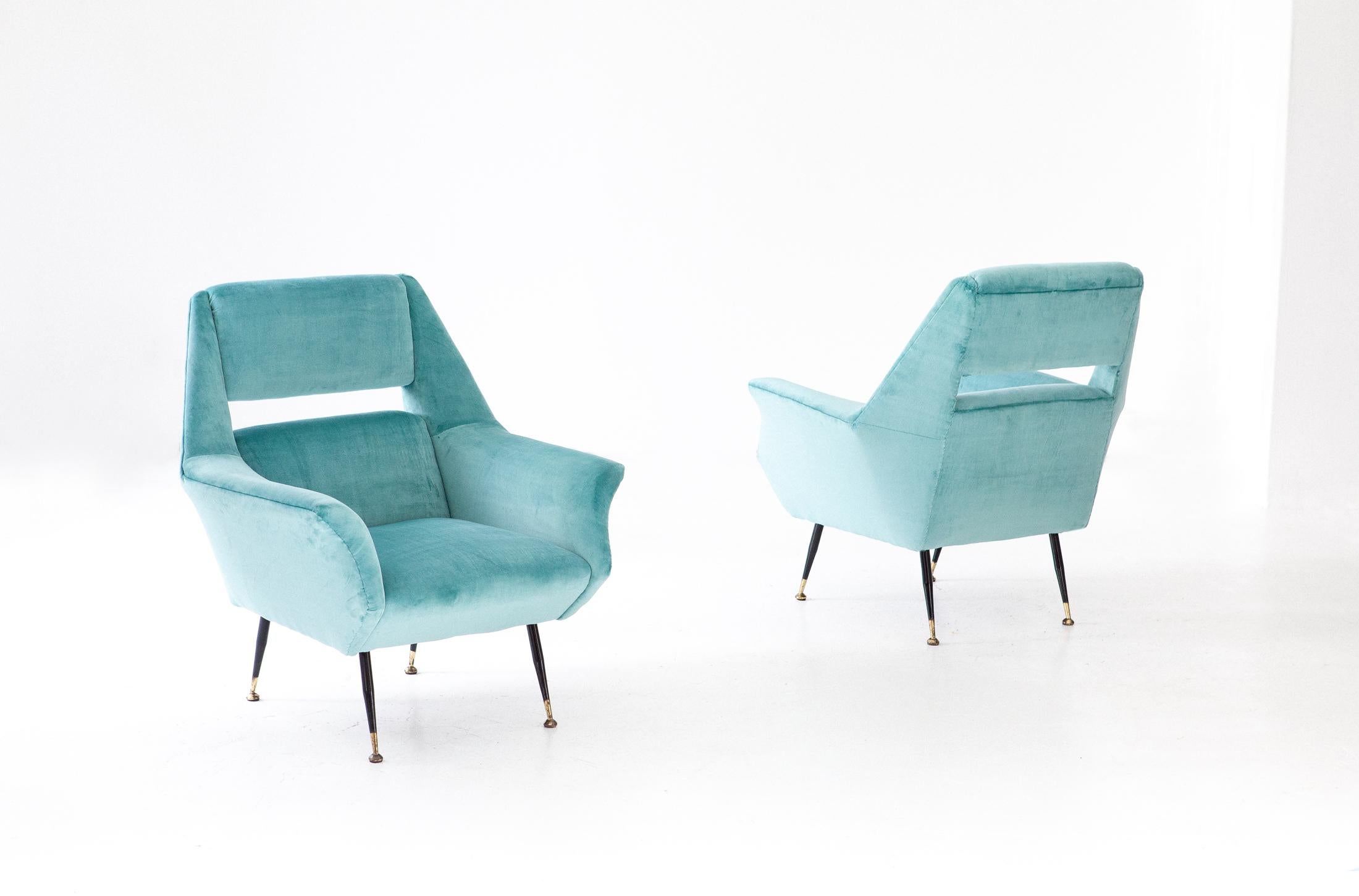 Set of two rare armchairs designed by Gigi Radice and produced by Minotti in Italy during the 1950s.

These original retro' chairs has been reupholstered with new velvet, also the padding is new. A turquoise that goes more 'towards the light blue