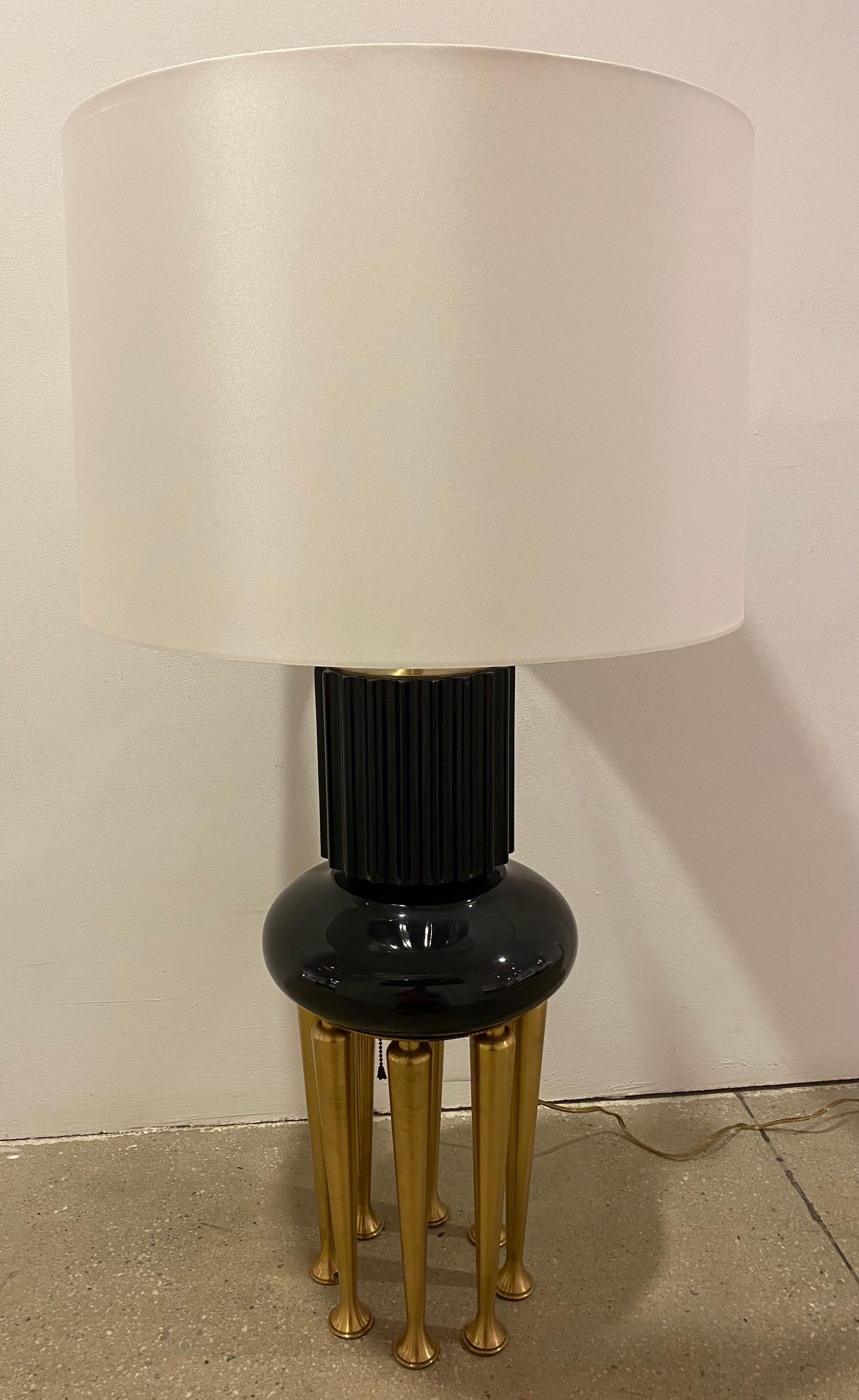 An iconic pair of American designer, James Mont’s War of the World Table lamps. They are composed of black enameled plaster bodies with polished bronze legs. The have a downward light under the body which illuminates the legs. Very good original