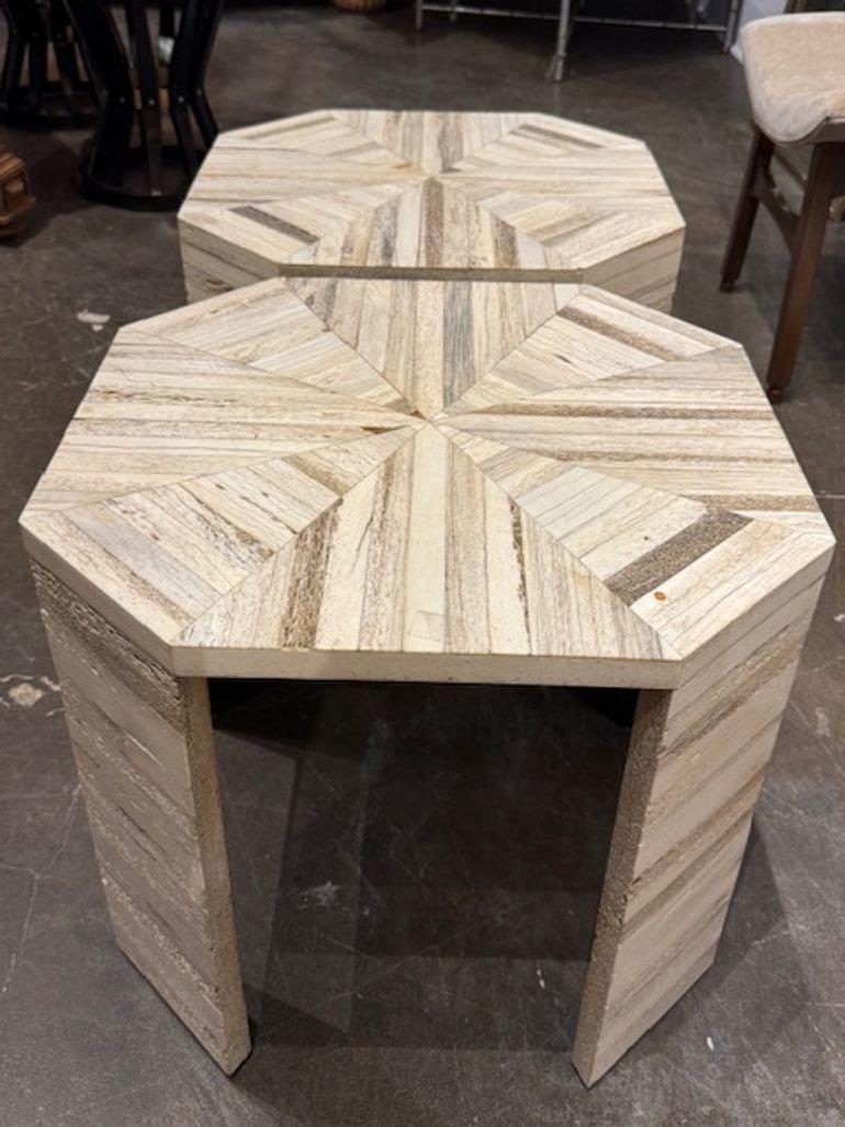 This product is a pair of rare Karl Springer bone side tables with a modern style. Known for their sleek and minimalist design, these tables are a luxurious addition to any home. The use of bone as a material adds a unique and elegant touch to the