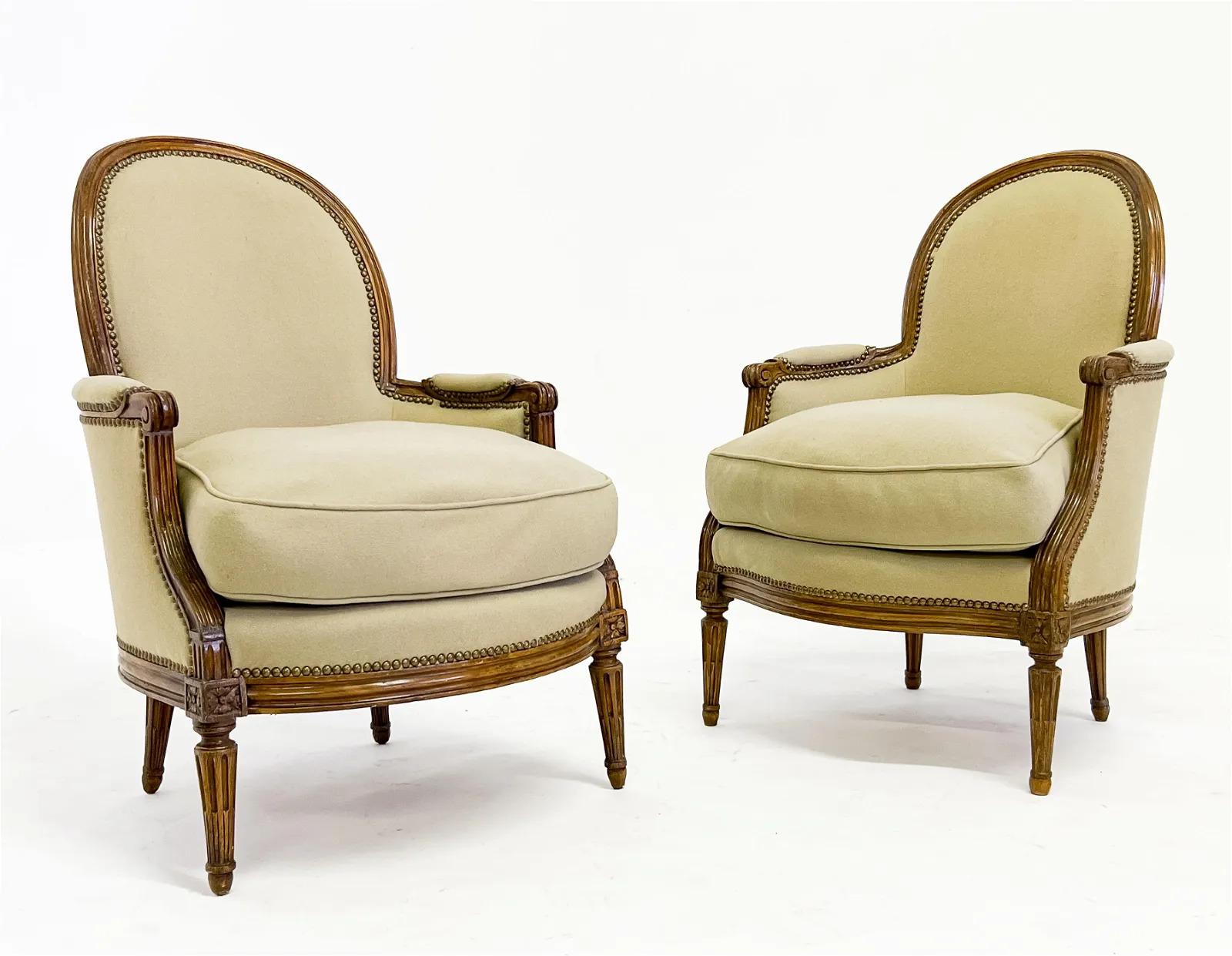 Pair of fine Louis XV Chevigny Stamped Bergères (late 18th century)
each with arched back and nailhead-trimmed upholstery, the frame with rosette details and raised on tapered fluted legs, underside stamped CHEVIGNY (Claude Chevigny, French, maitre