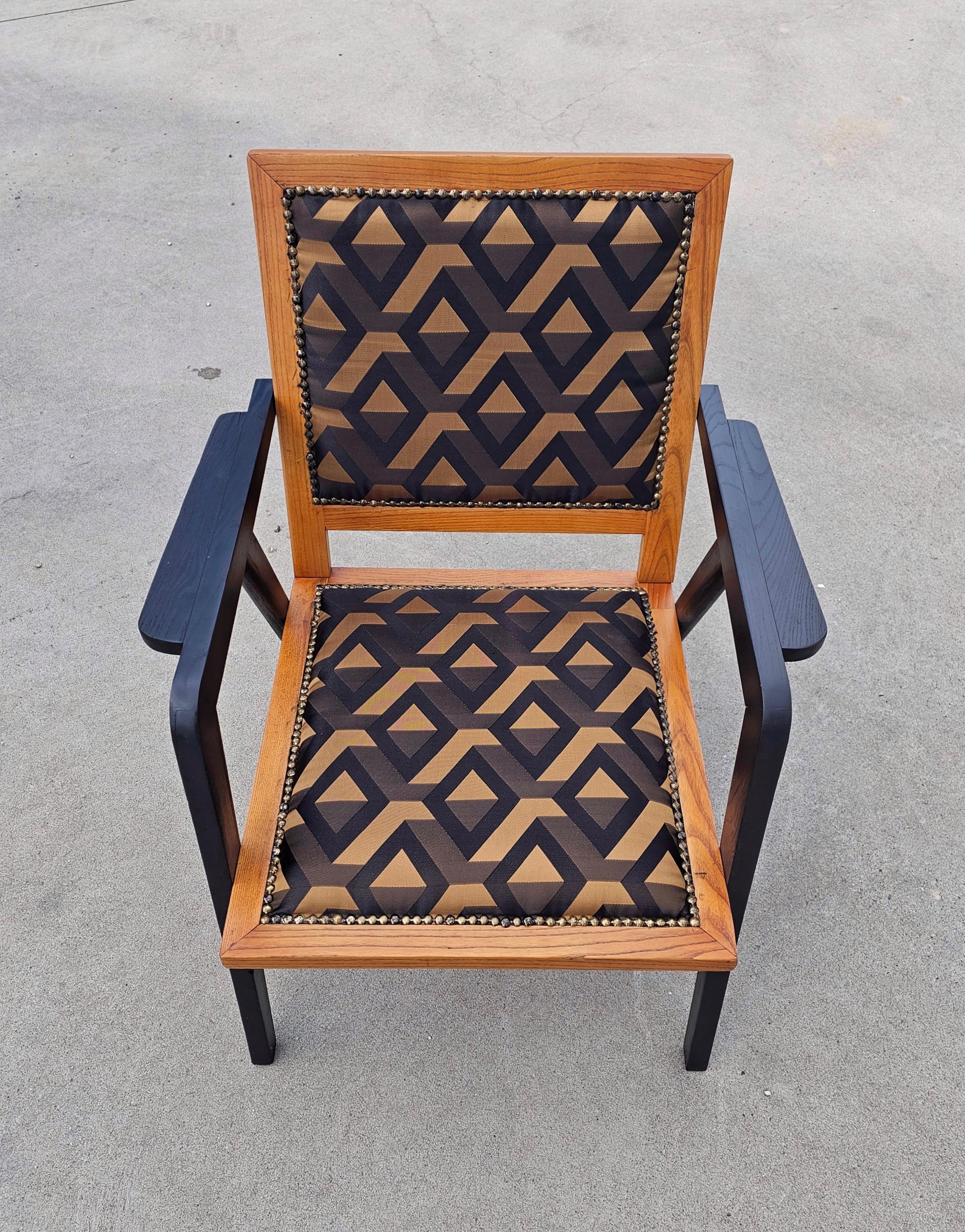 In this listing you will find a pair of very rare, fully refurbished Mid-Century Modern Armchair done in Ebonized Oak Wood and Jacquard Fabric with Art Deco Inspired Print in black, gold and anthracite. The armchairs feature unique shape of the legs