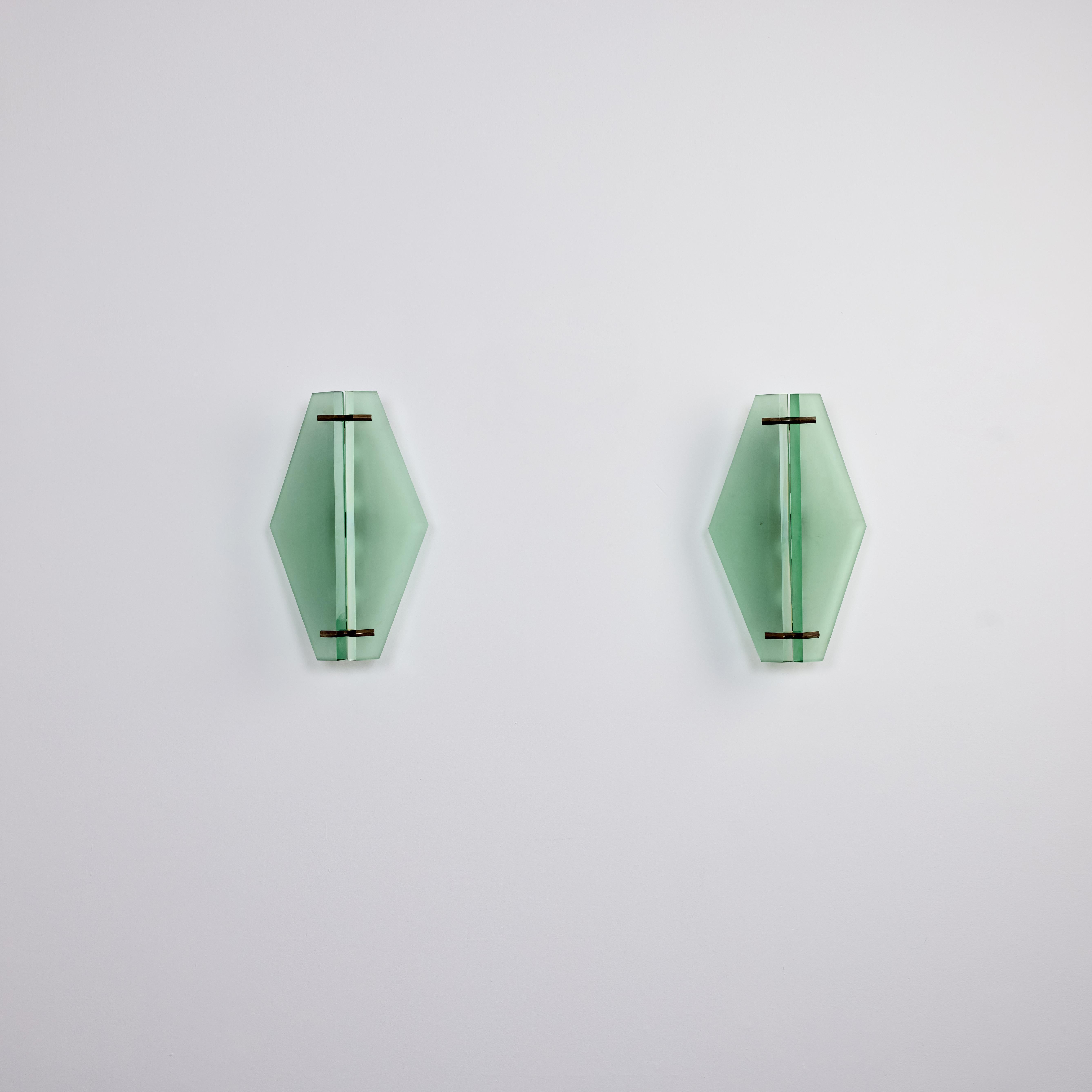 Paar seltene Wandleuchter Modell 1943 von Max Ingrand für Fontana Arte. Etwa in den 1960er Jahren. 

Dickes geschliffenes Glas von Fontana Arte mit einer Rautenform. Jede Leuchte ist mit zwei Schnitten versehen, mit schwarzer Emaille und