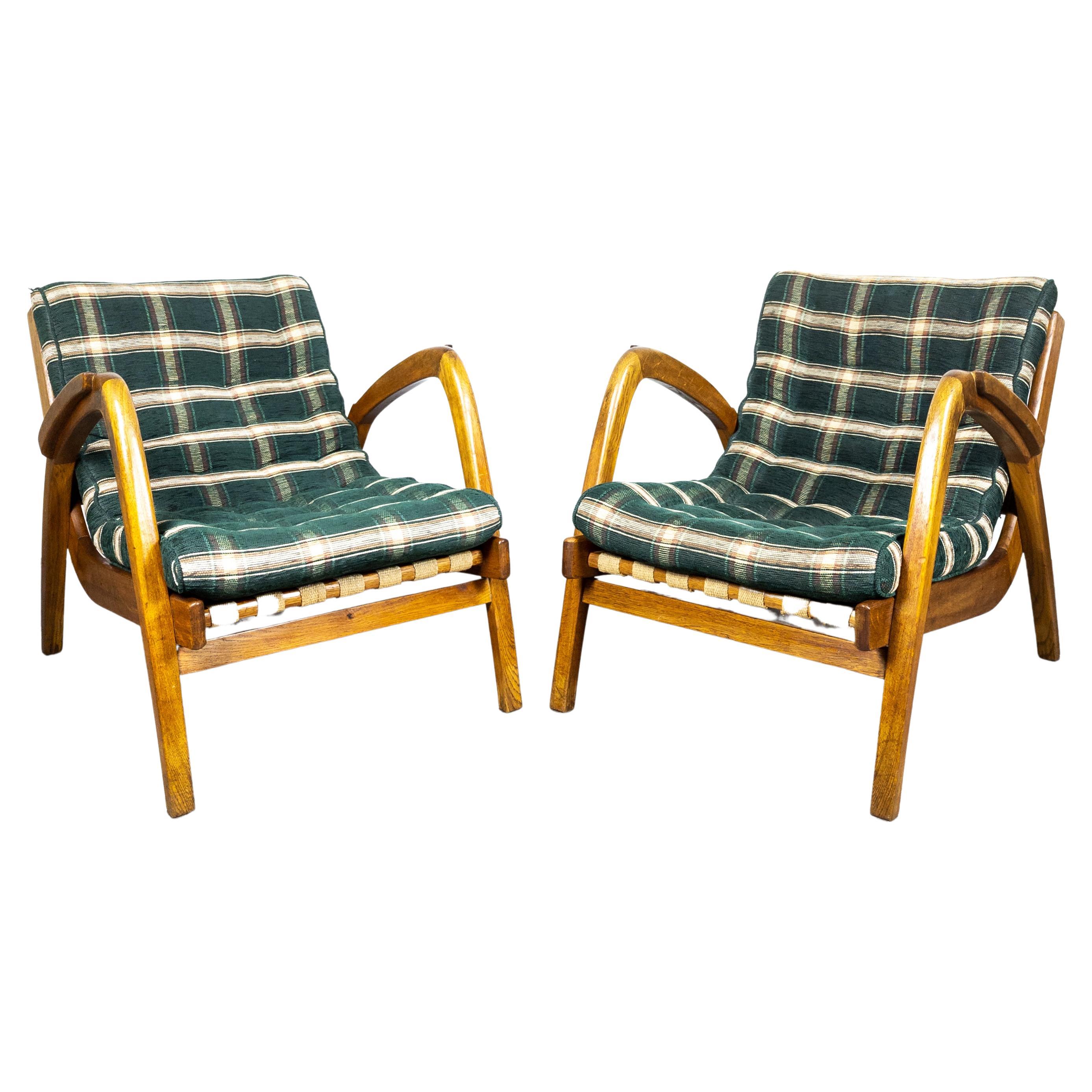 Pair of rare and unique armchairs designed by Jan Vanek for Krásná Jizba, former Czechoslovakia in 1940´s. It features a woven canvas seat and beech wood frame. In very good original condition with beautiful patina on the wood. Both the wood and the