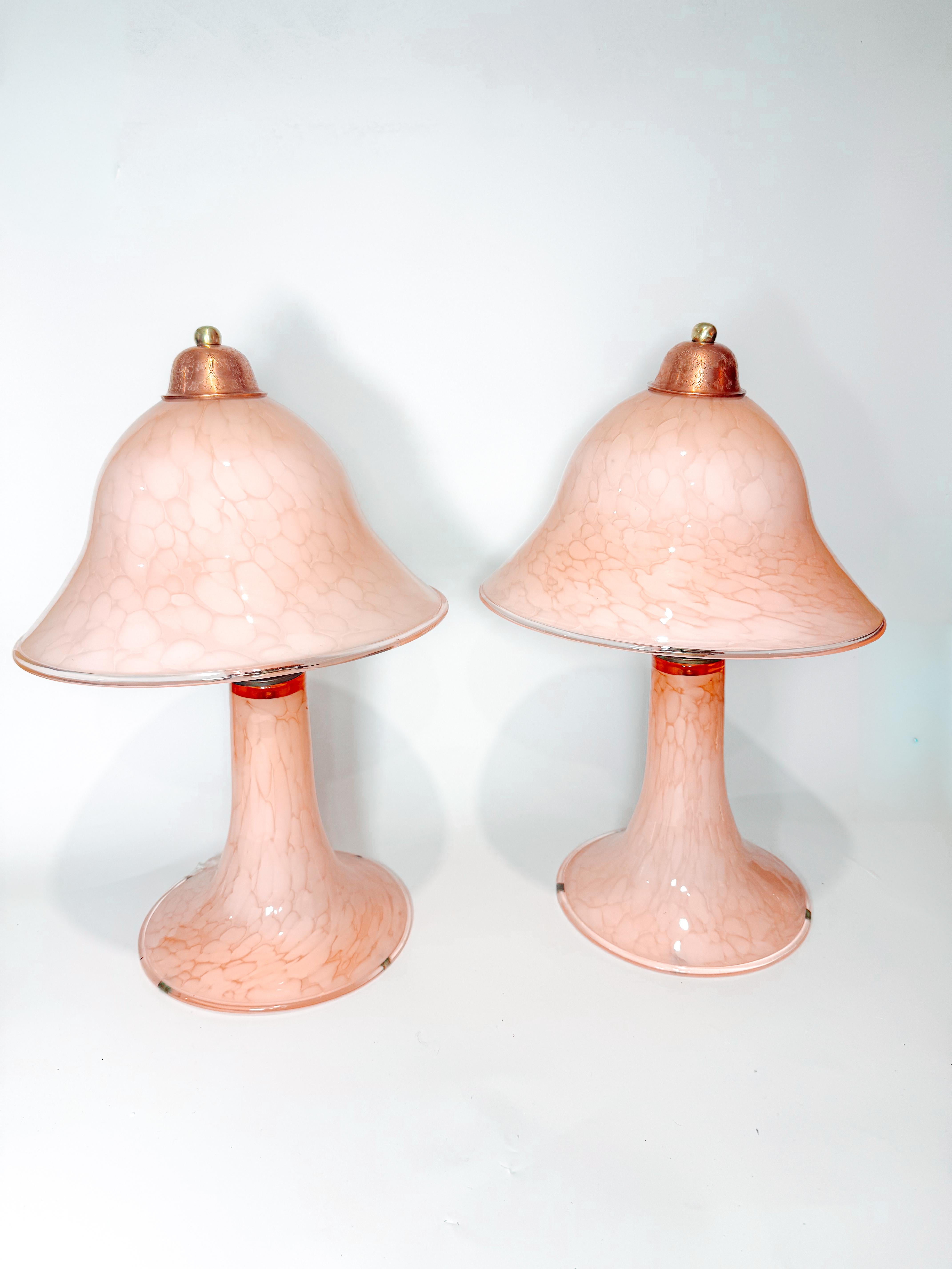 Stunning and rare pair of vintage Murano glass mushroom lamps, handcrafted in Italy during the 1970s. Each lamp features a soft pink “clouds” pattern — a hallmark of Murano artistry — that diffuses light into a warm, ethereal glow. Their organic