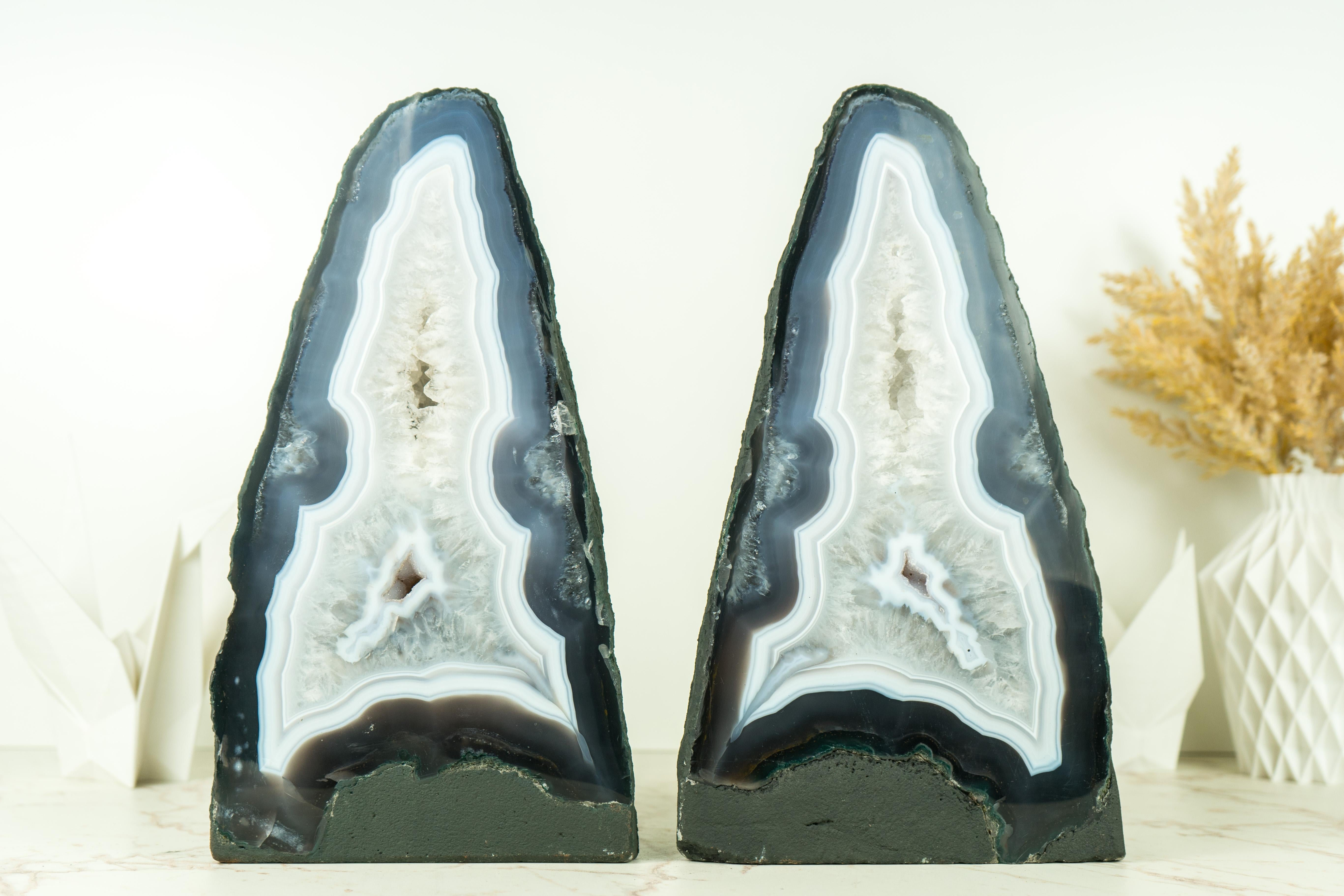 A pair of gorgeous, intact agate with blue and white laces, this pair of agate geodes is considered to be of super-extra quality due to its beauty, formation, and the aesthetical agate bands that surround both geodes. Outstanding specimens, these