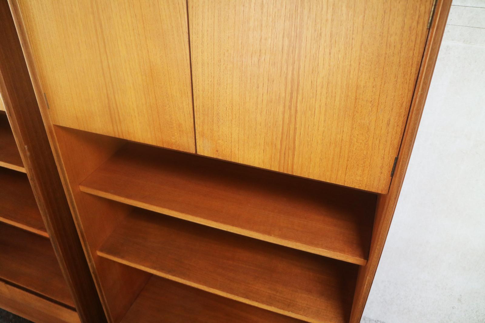 Two matching shelving units by G Plan. minimally designed with a Danish sensibility. Two cupboards at the top and two drawers at the bottom of each unit. Open book shelving in between. Original label on each unit.

The price listed is for the two