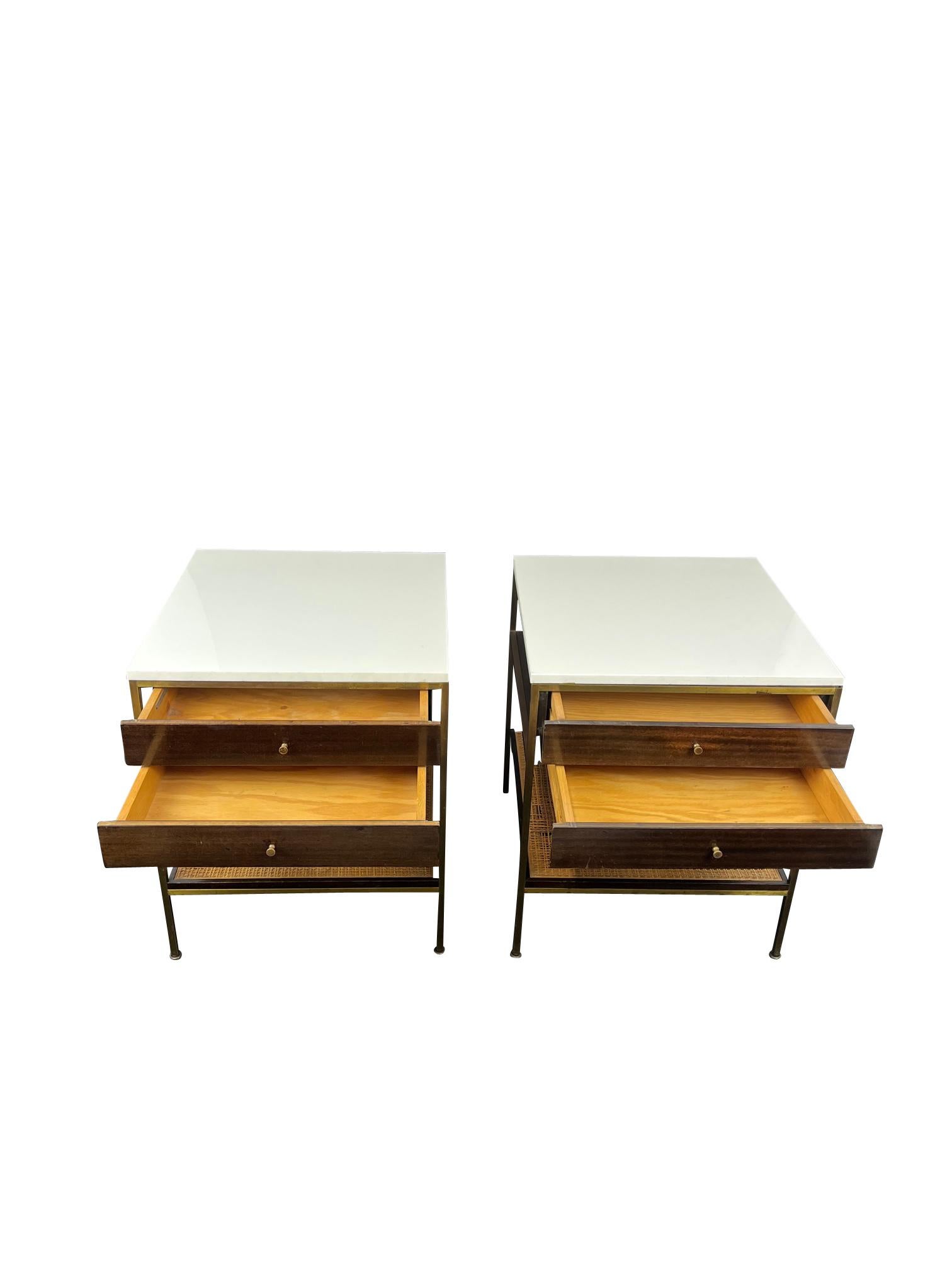 Rare Paul McCobb bedside tables. They are a excuisite combination of elegant materials of Carrara Marble brass, Walnut drawers and Cane shelves.

