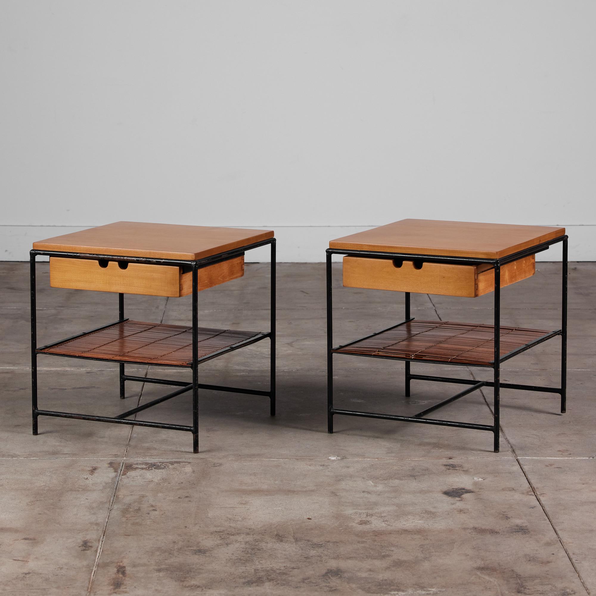 A pair of highly desirable and rare Paul McCobb nightstands from his Planner Group collection for Winchedon, c.1950s. The pair features an exposed wrought iron frame, single maple drawer and top, and lower shelf made from bamboo slats.

Dimensions: