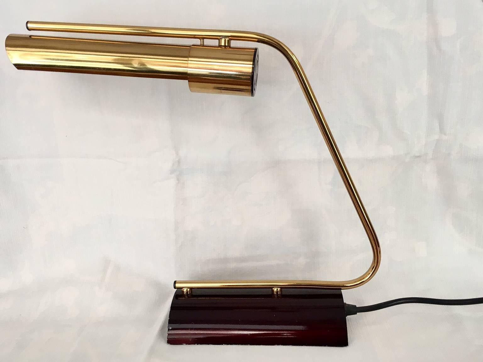 Pair of rare Philips desk-lamps made of gold brass with a lacquered brass base in maroon.