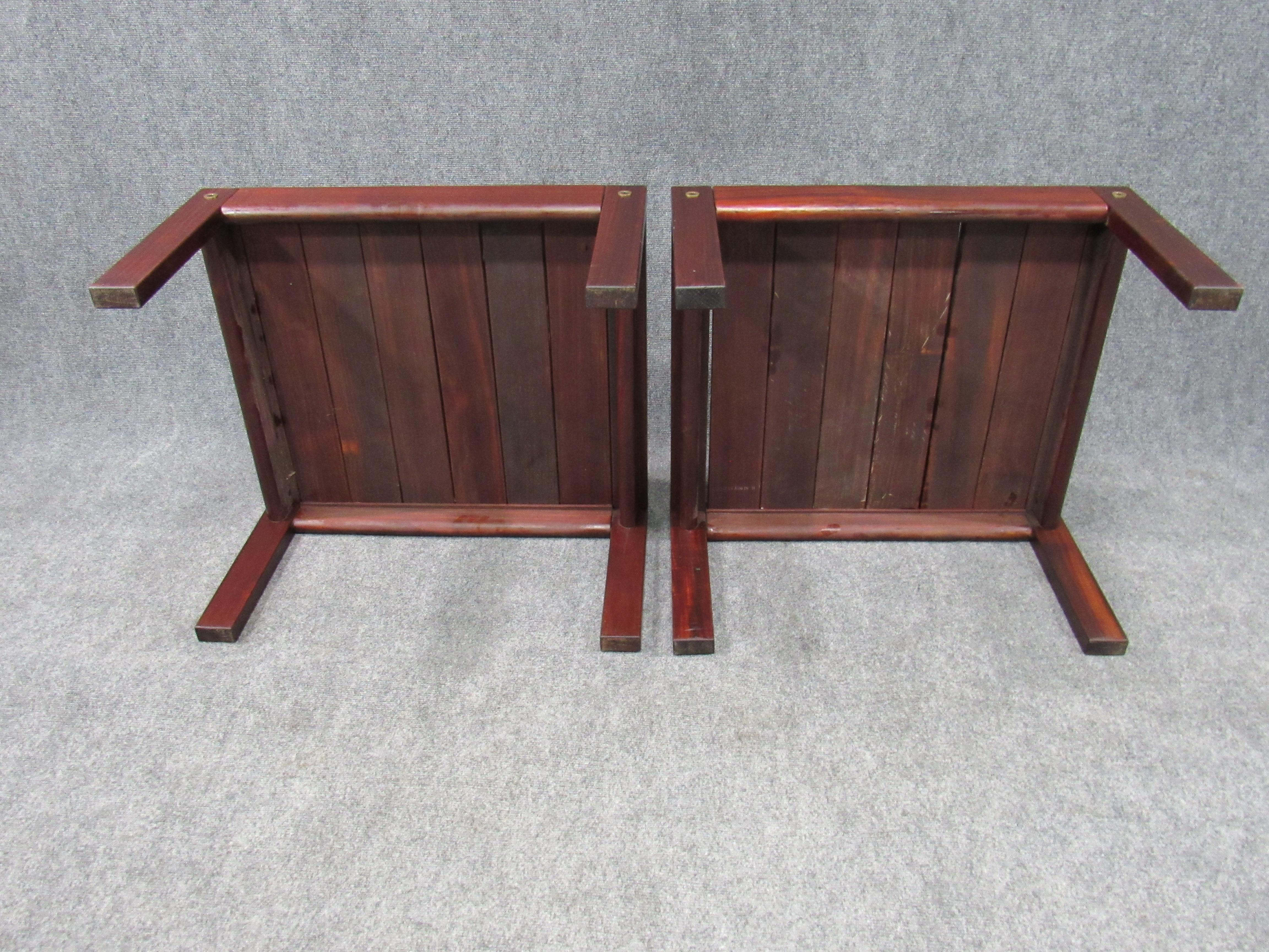 Pair of rare solid midcentury 1960s Brazilian modern Jacaranda rosewood ottomans or stools or end tables attributed to Jacaranda. The simple yet elegant design is similar in style to pieces designed by other prominent midcentury designers from