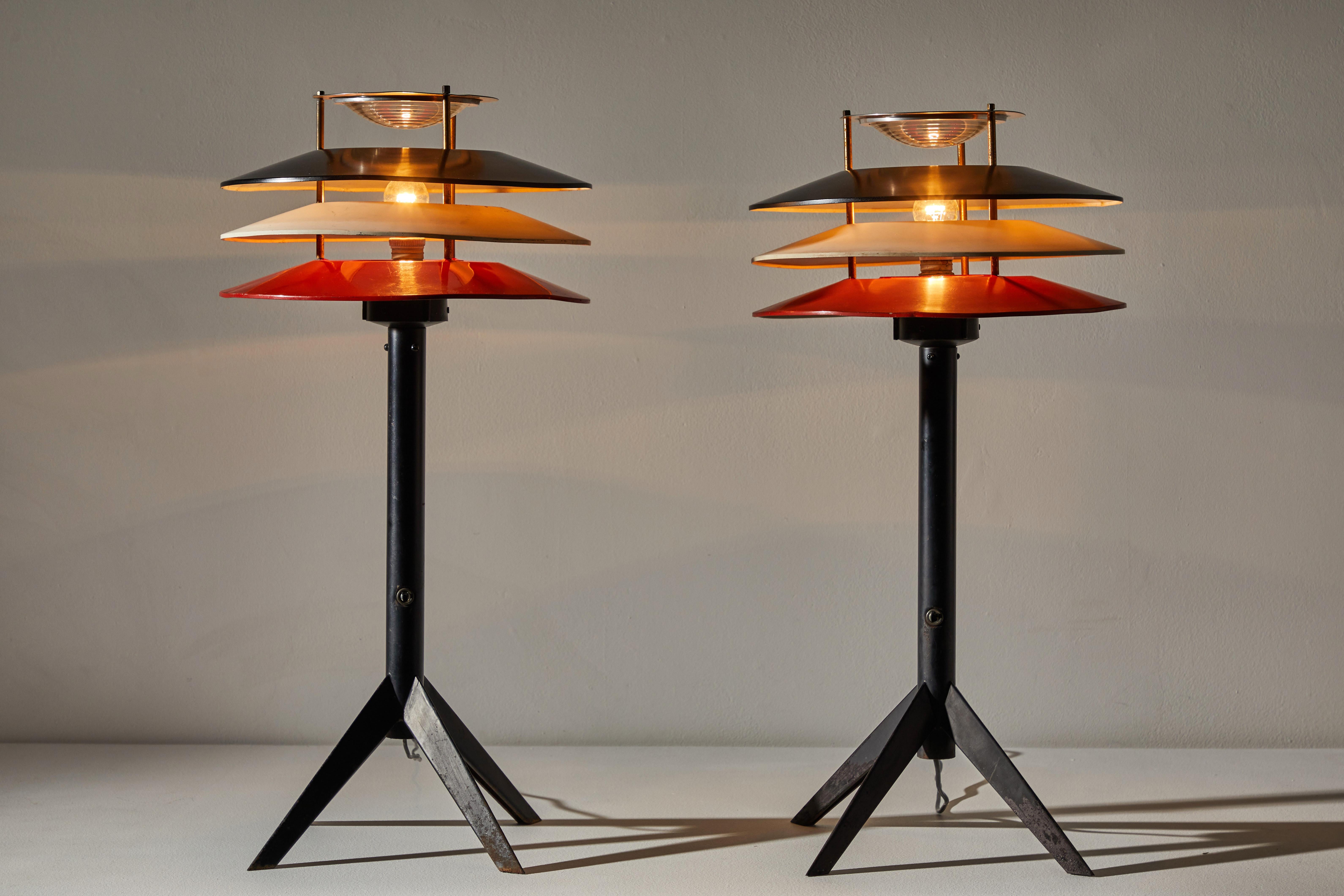 Pair of rare Stilnovo table lamps. Manufactured in Italy, circa 1950s. Enameled metal, brass, glass diffuser. Original cord. Each light takes one E27 100w maximum bulb. Bulbs provided as a one time courtesy. Light retains the original manufacturer's