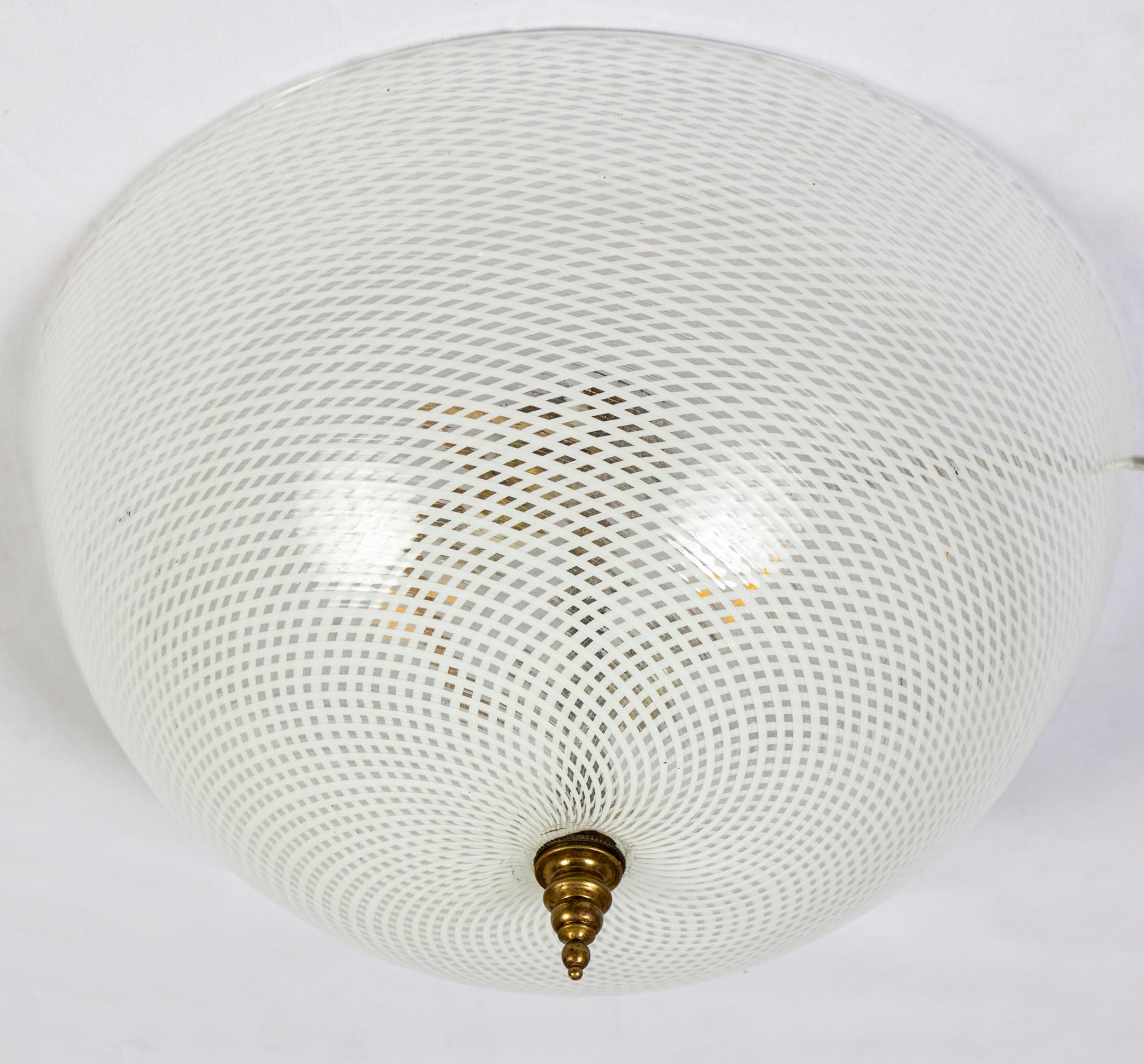 Amazing and rare pair of ceiling lights with a precious hand blown reticello Murano glass semi-sphere 1940'. Excellent original condition. 
 3 E 14 Light bulb 40 Watt.
 

