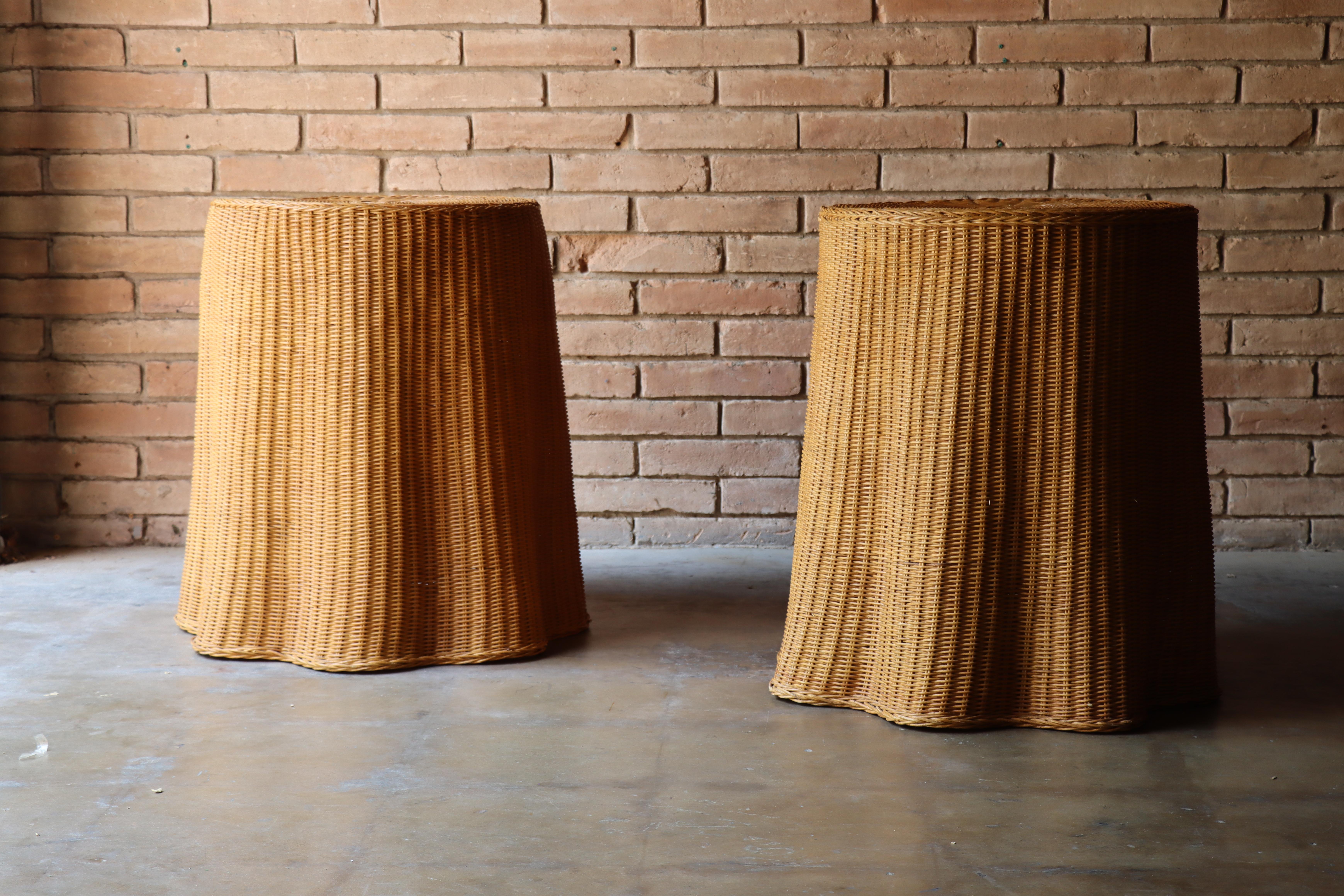Rare pair of vintage organic trompe l’oeil wicker side tables or stands. These examples have a lovely draped illusion adding to their sophistication yet playfulness form. The vintage rattan has a rich warm coloring only age can produce. 

Would be