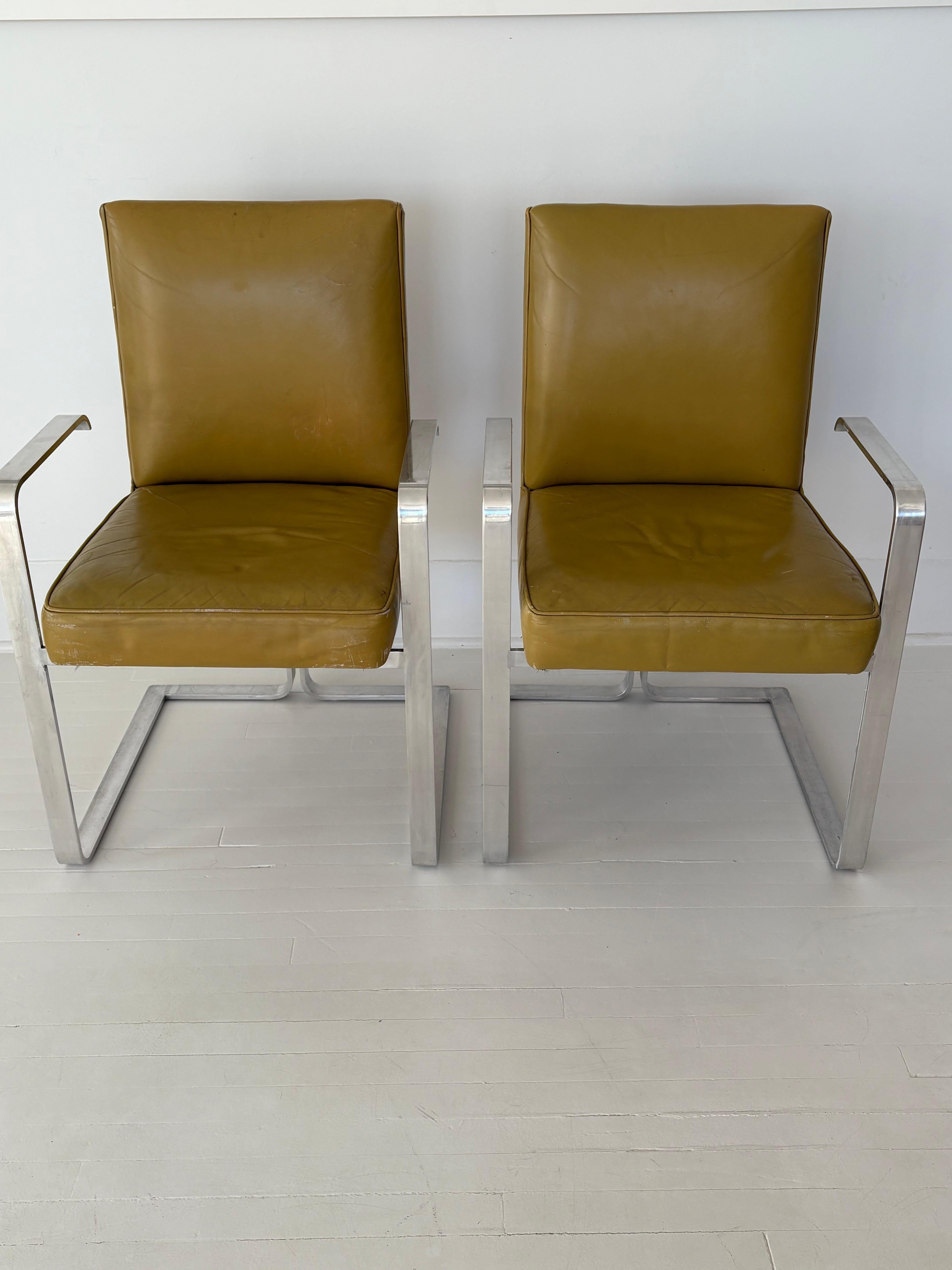 These rare chairs were designed in the 1960s by Vladimir Kagan for Kagan-Dreyfuss in NYC. The seats are leather and the base and arms are stainless steel. Sleek modern high design and high quality with that cool Kagan look . I believe they were