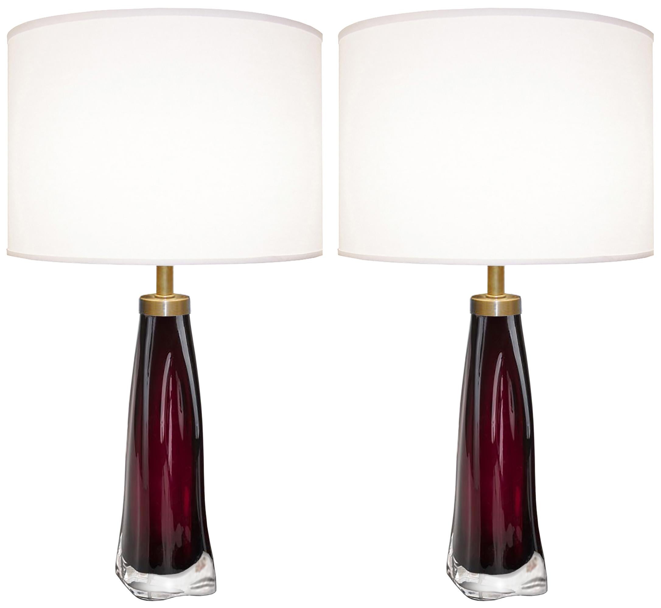 A pair of raspberry and clear glass lamps with brass hardware by Carl Fagerlund for Orrefors, Swedish, 1950s.