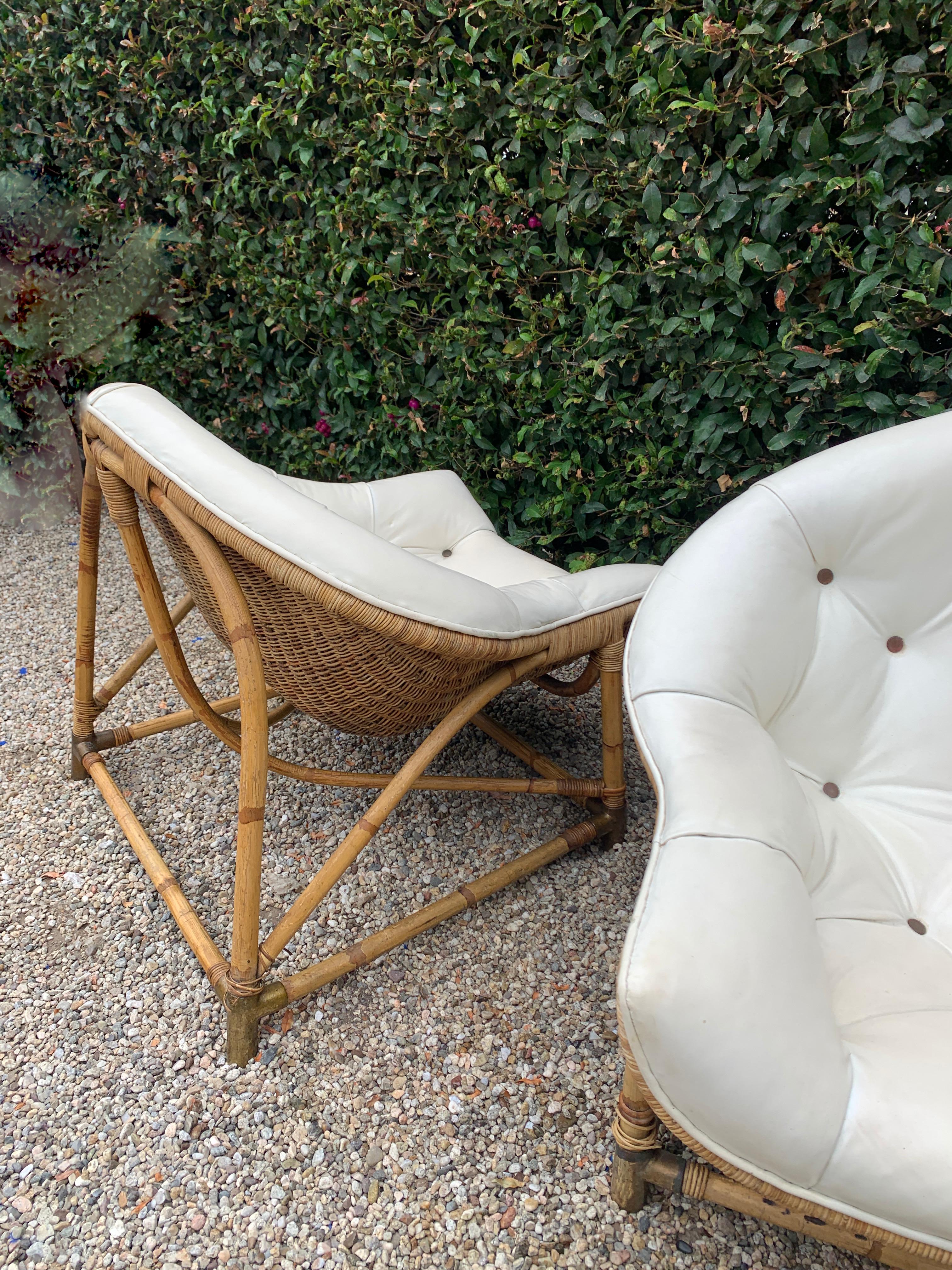 Unique and well designed, a pair of Rattan and Bamboo Lounge chairs. The vintage pair have a very intricate and well thought out design with brass sabots. The seats are very comfortable and also in a unique and moorish shaped cushion. 

Low and