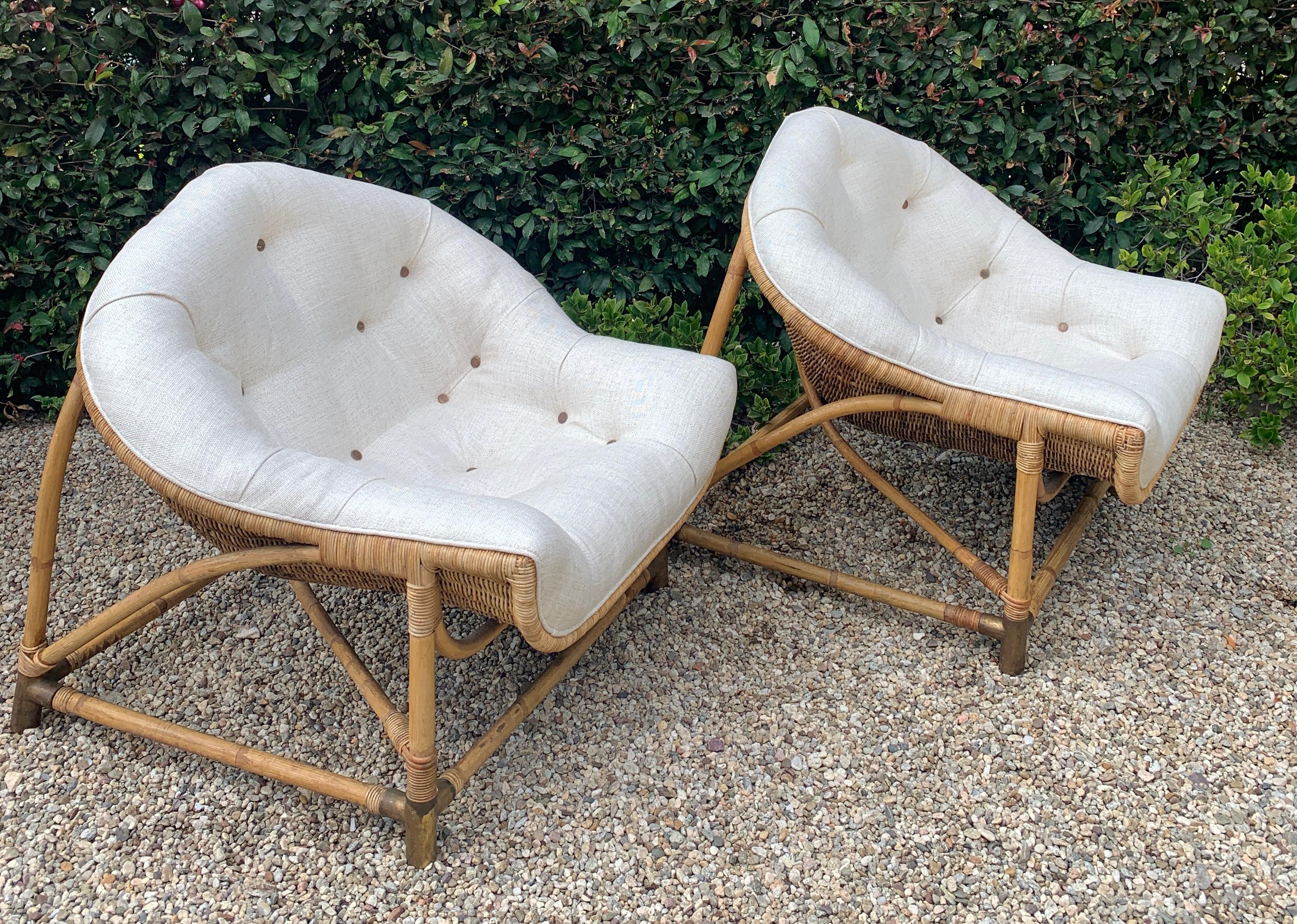 Unique and well designed, a pair of Rattan and Bamboo Lounge chairs. The vintage pair have a very intricate and well thought out design with brass sabots. The seats are very comfortable and also in a unique and moorish shaped cushion. 

Low and