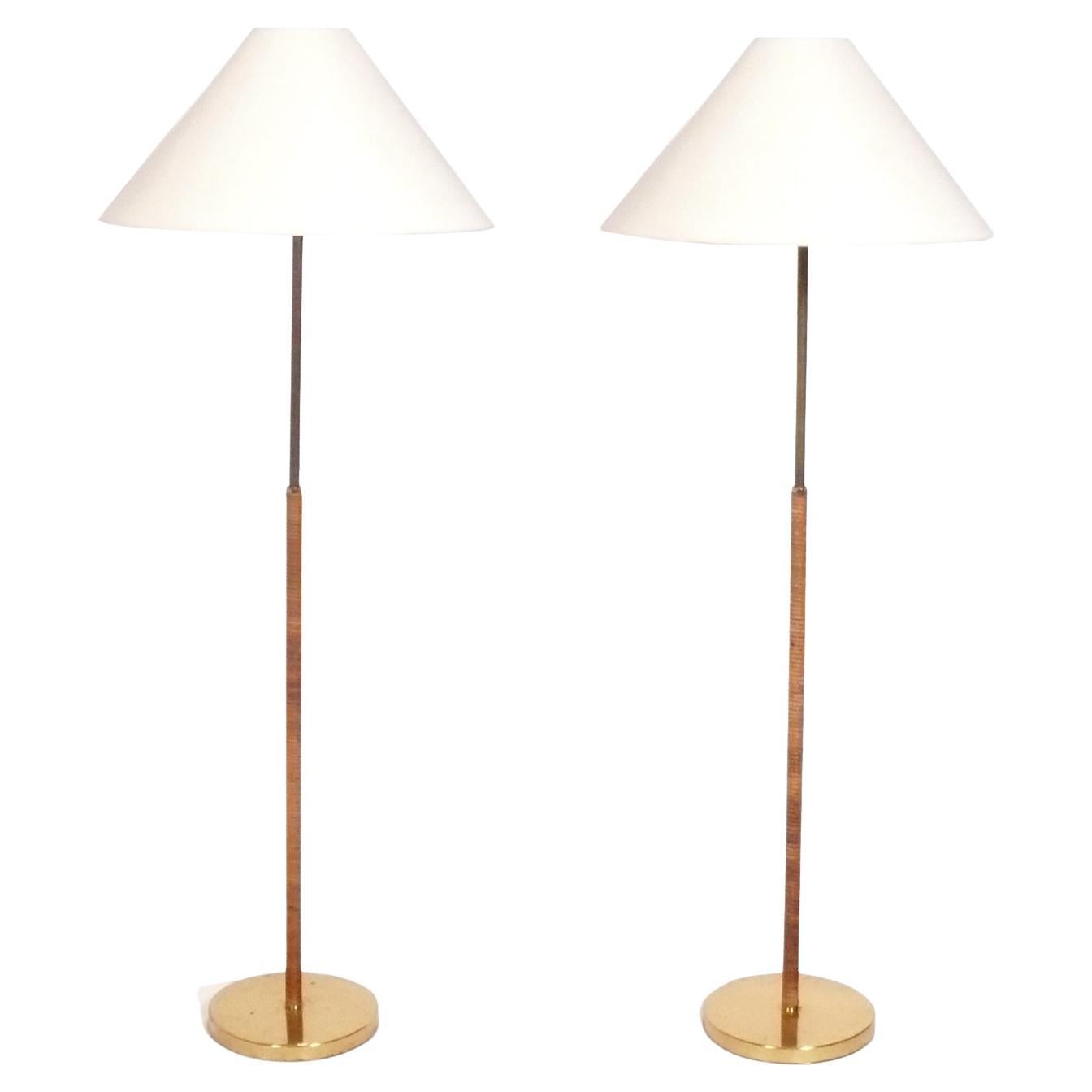 Pair of Rattan and Brass Floor Lamps in the Manner of Paavo Tynell